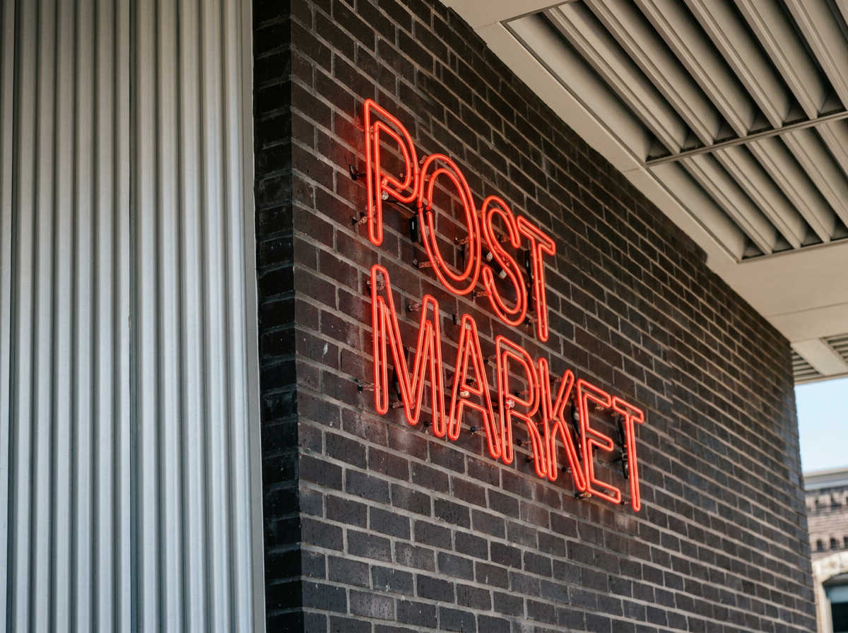 Neon sign reading 'POST MARKET' in red mounted on a brick wall outside a building.