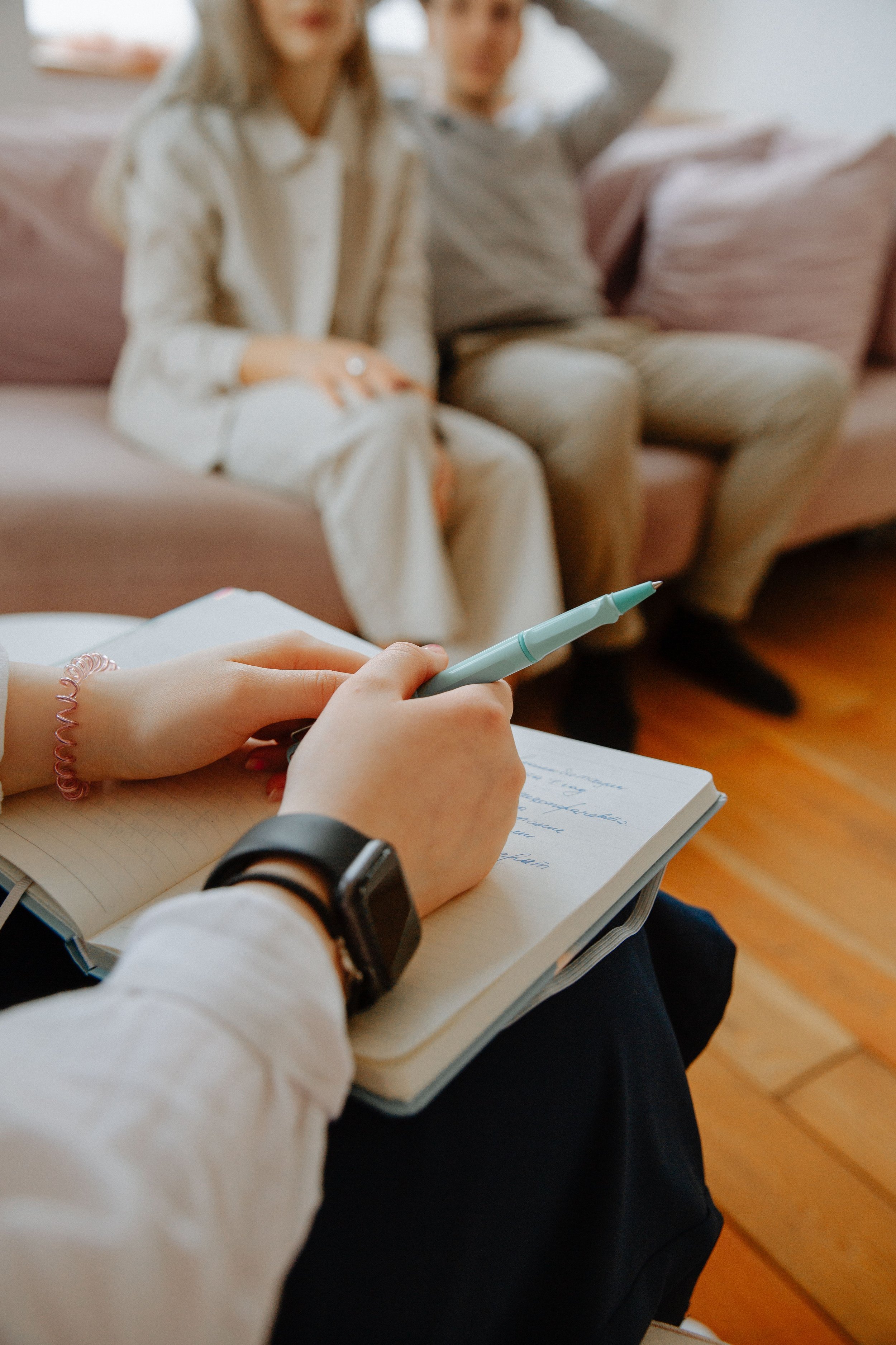 Therapist taking notes during an individual counseling session.