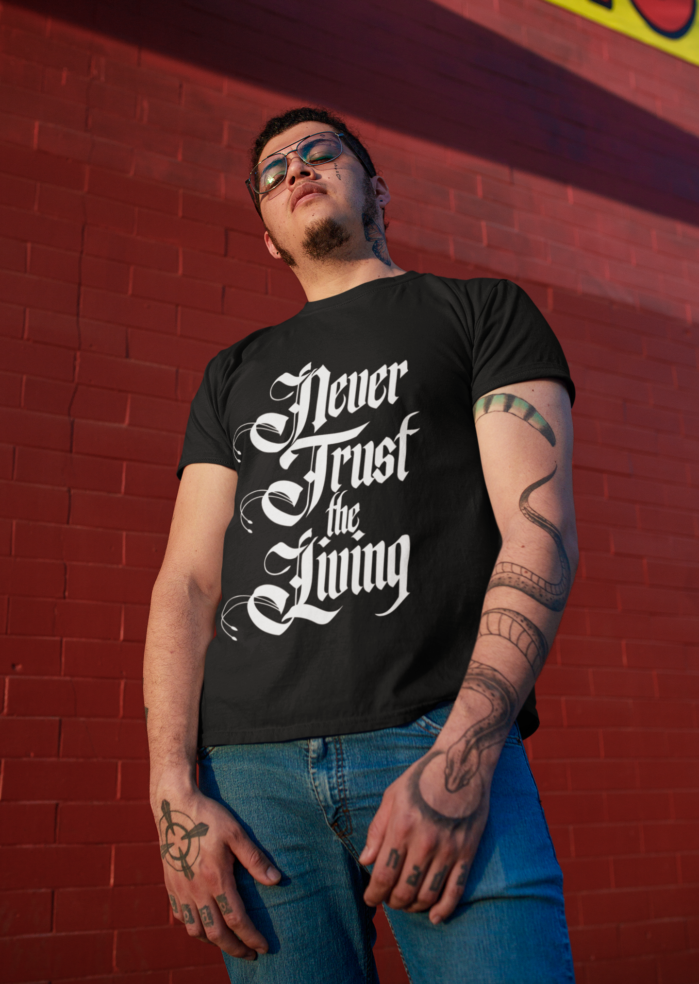 t-shirt-mockup-of-a-tough-looking-man-posing-in-front-of-a-red-brick-wall-32817.png
