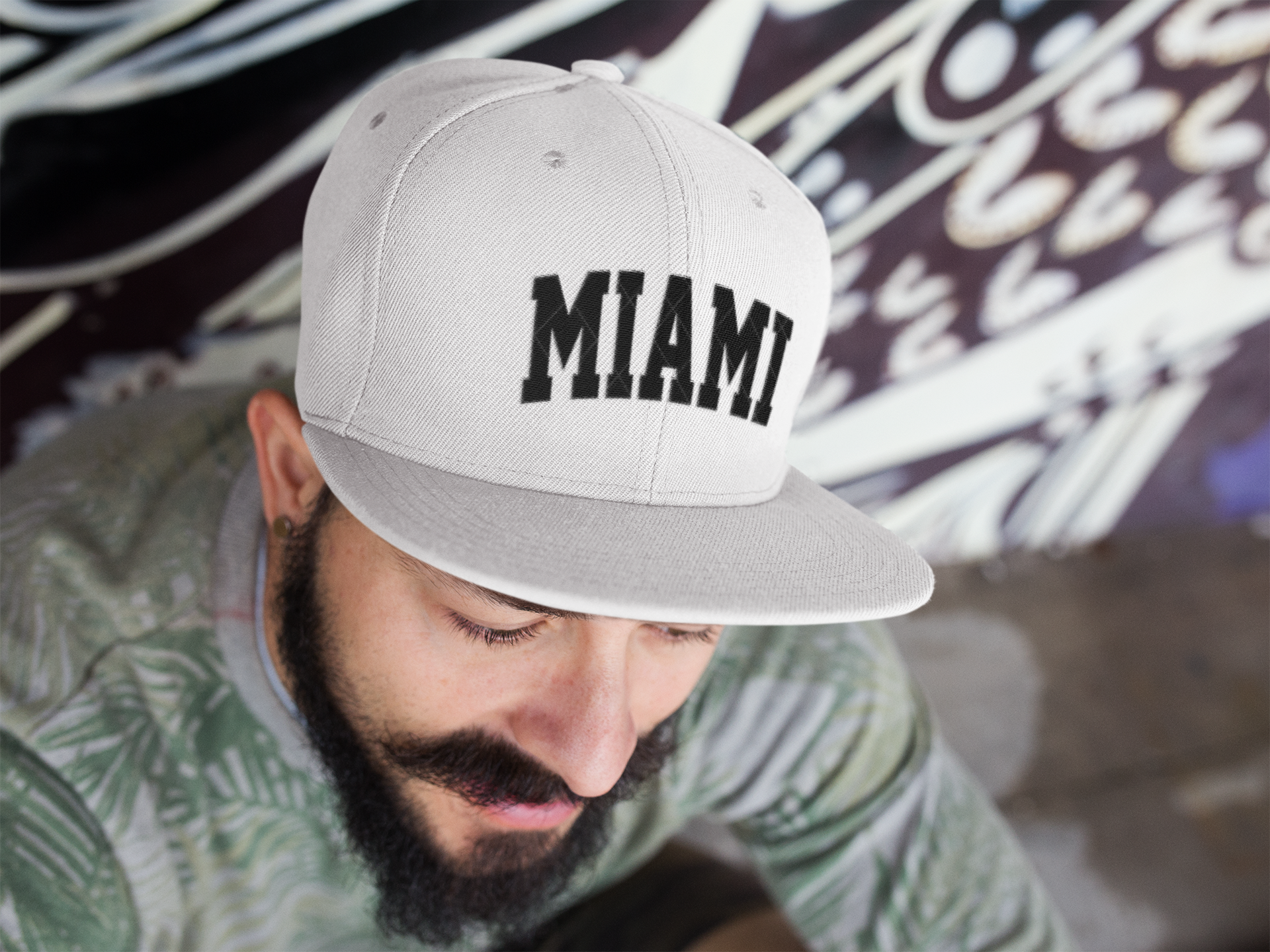 young-man-sitting-with-a-snapback-hat-mockup-11839.png
