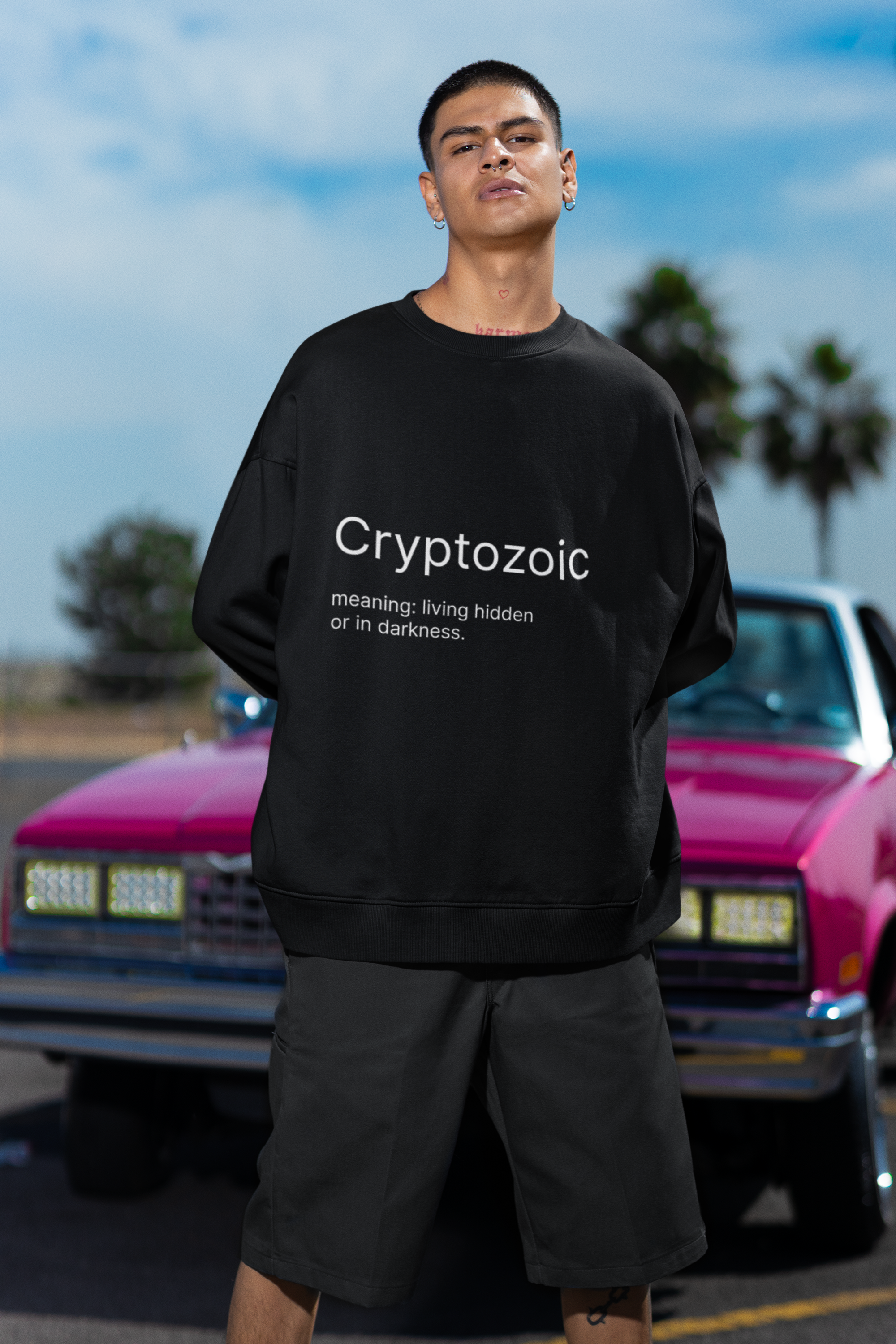 oversized-sweatshirt-mockup-featuring-a-serious-man-with-tattoos-posing-against-a-car-m36810.png