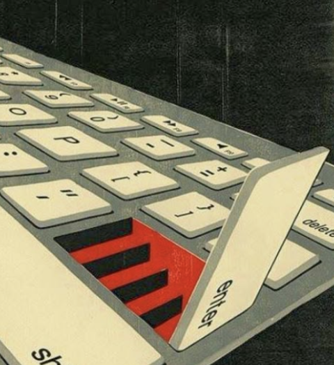 Close-up of a computer keyboard with a key labeled 'Delete' partially popped up, revealing a red and black striped pattern on the underlying surface.
