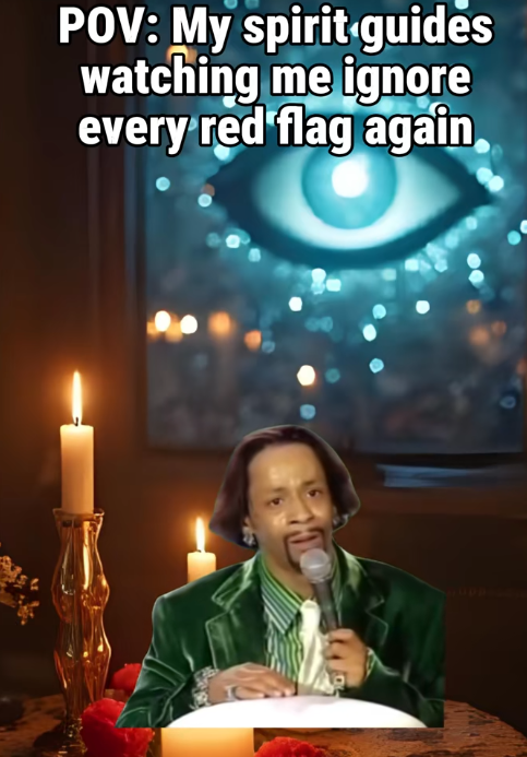 A man in a green jacket and striped shirt speaking into a microphone, sitting at a table with candles and red flowers, in front of a large screen showing an eye with a blue glow and swirling lights, with text overlay reading 'POV: My spirit guides watching me ignore every red flag again'.