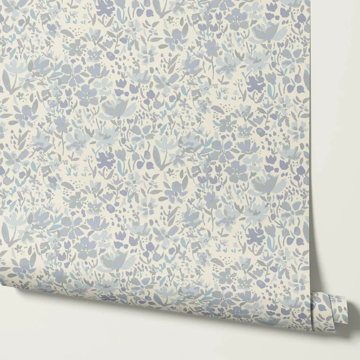 Close-up of floral patterned wallpaper with small blue and gray flowers on a cream background.