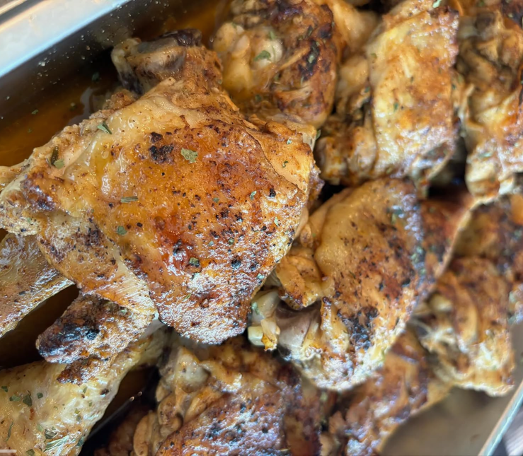 Close-up of seasoned and cooked chicken drumsticks with crispy, golden-brown skin.