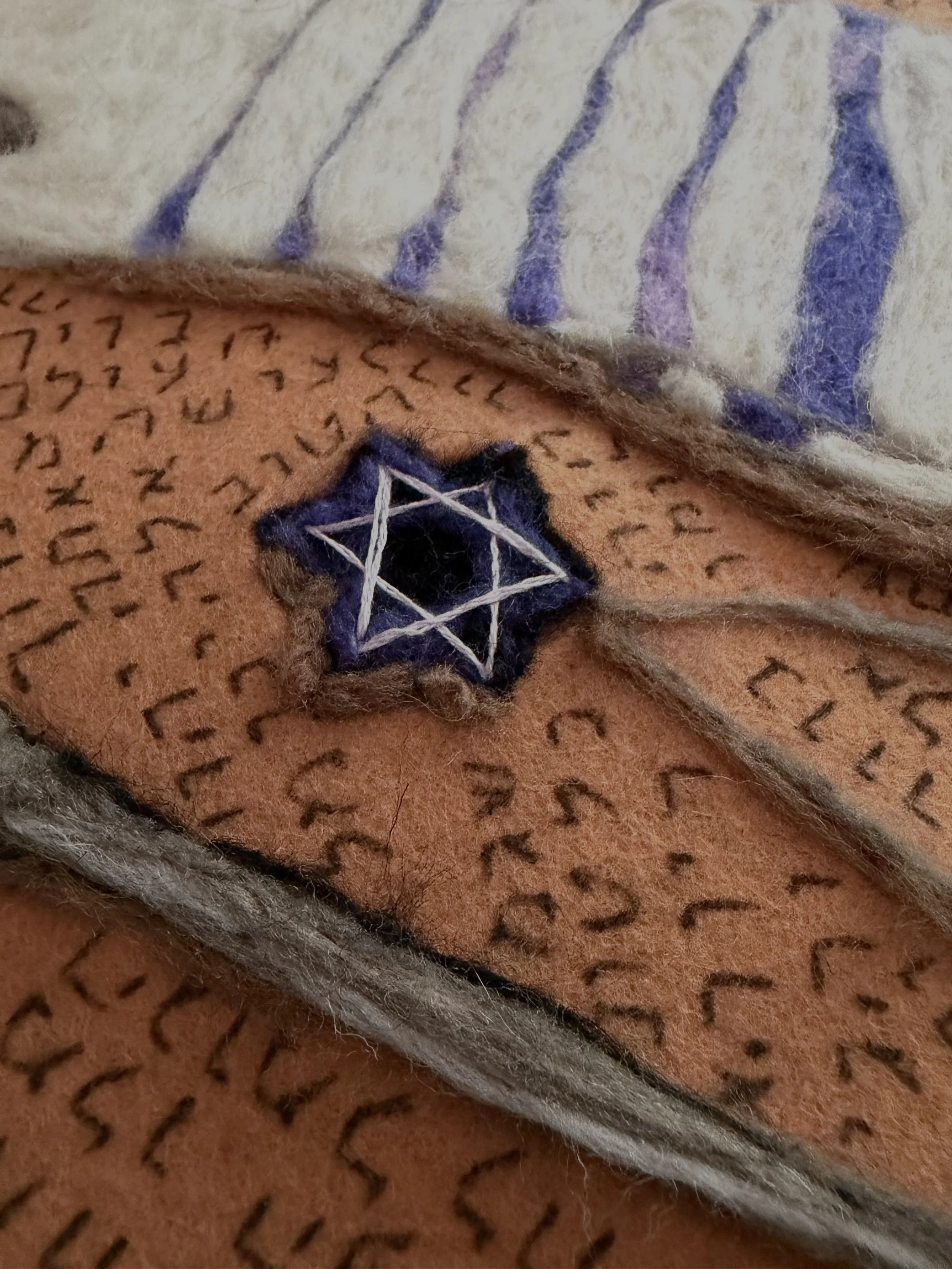 Close-up of a Star of David and Hebrew writing.