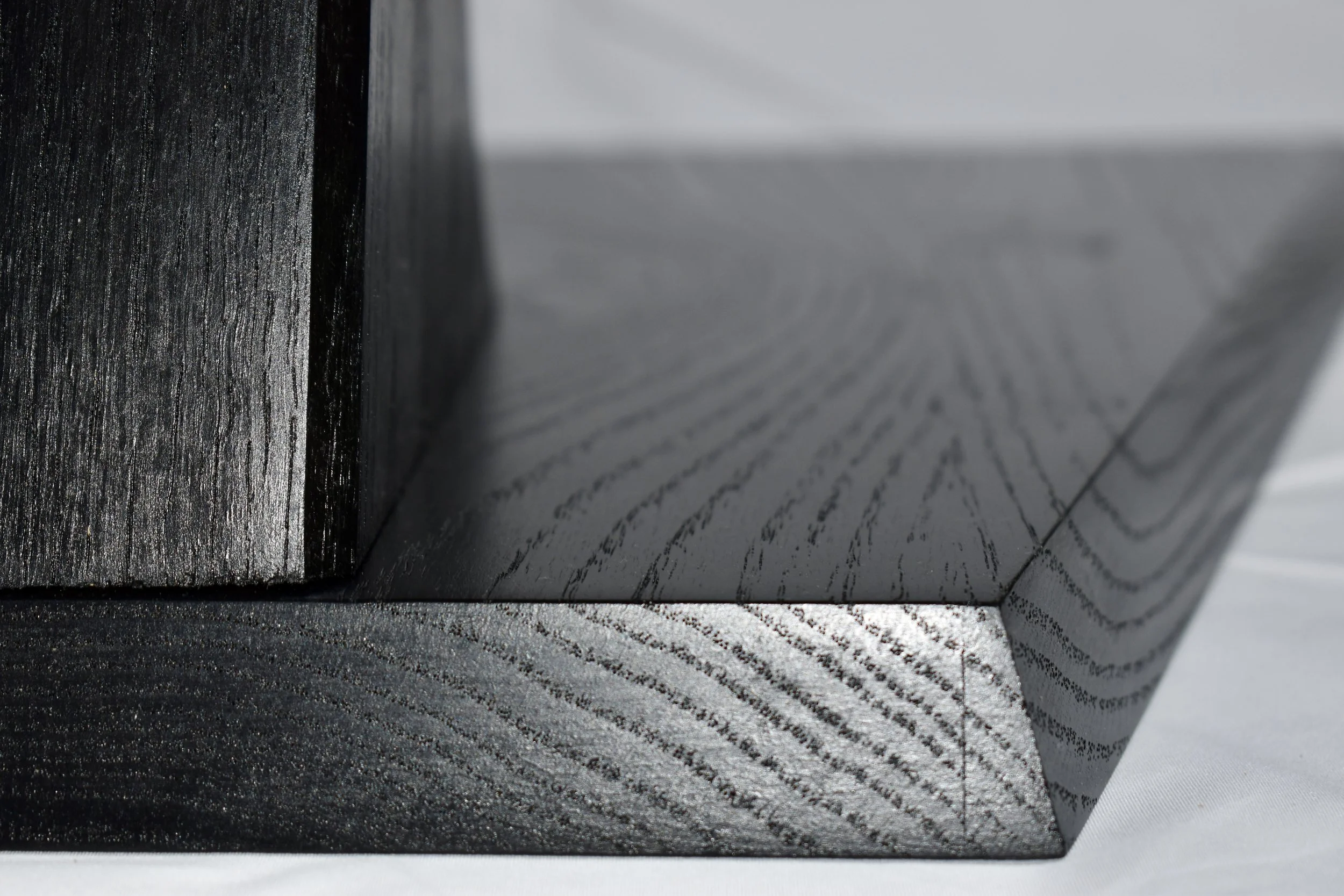 Close-up of a stack of black and gray printed documents or booklets with textured surfaces.
