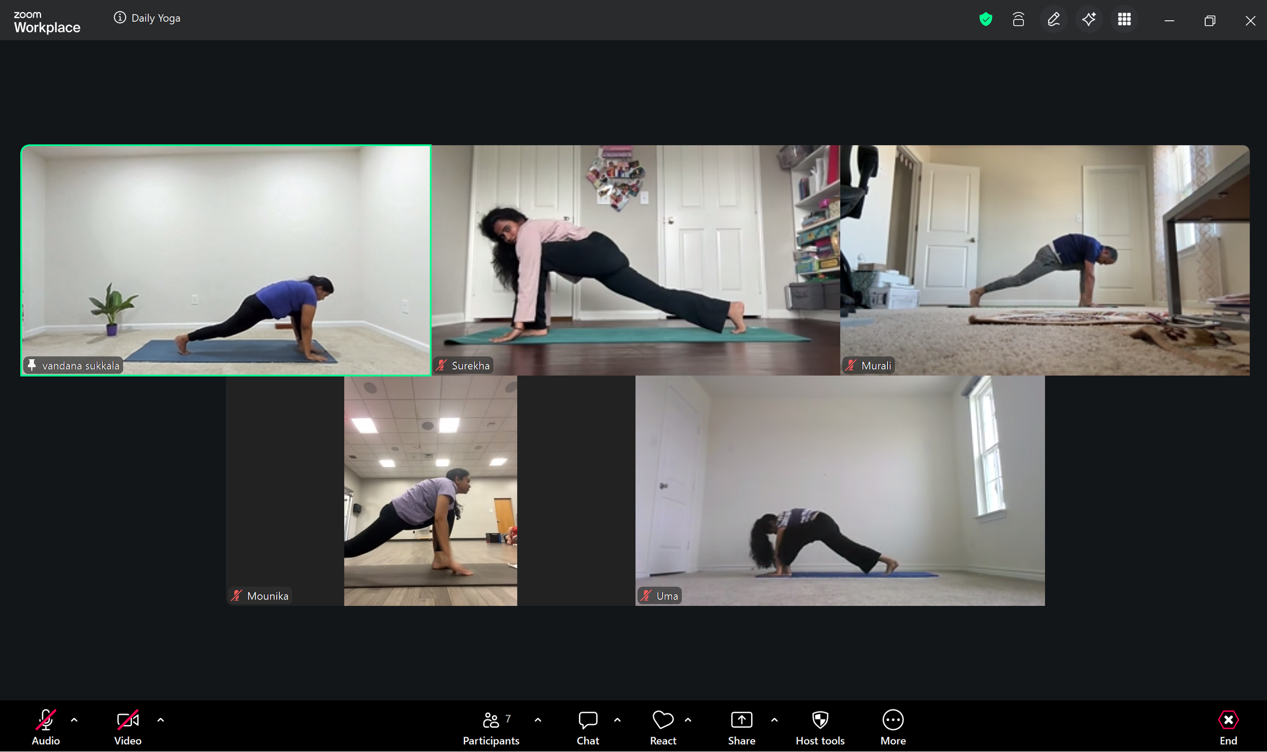 Screenshot of a virtual yoga class with multiple participants performing yoga poses in their respective rooms.