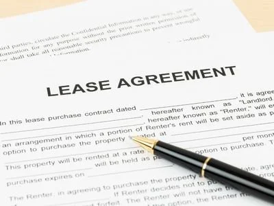 A lease agreement document with a black and gold pen resting on it.