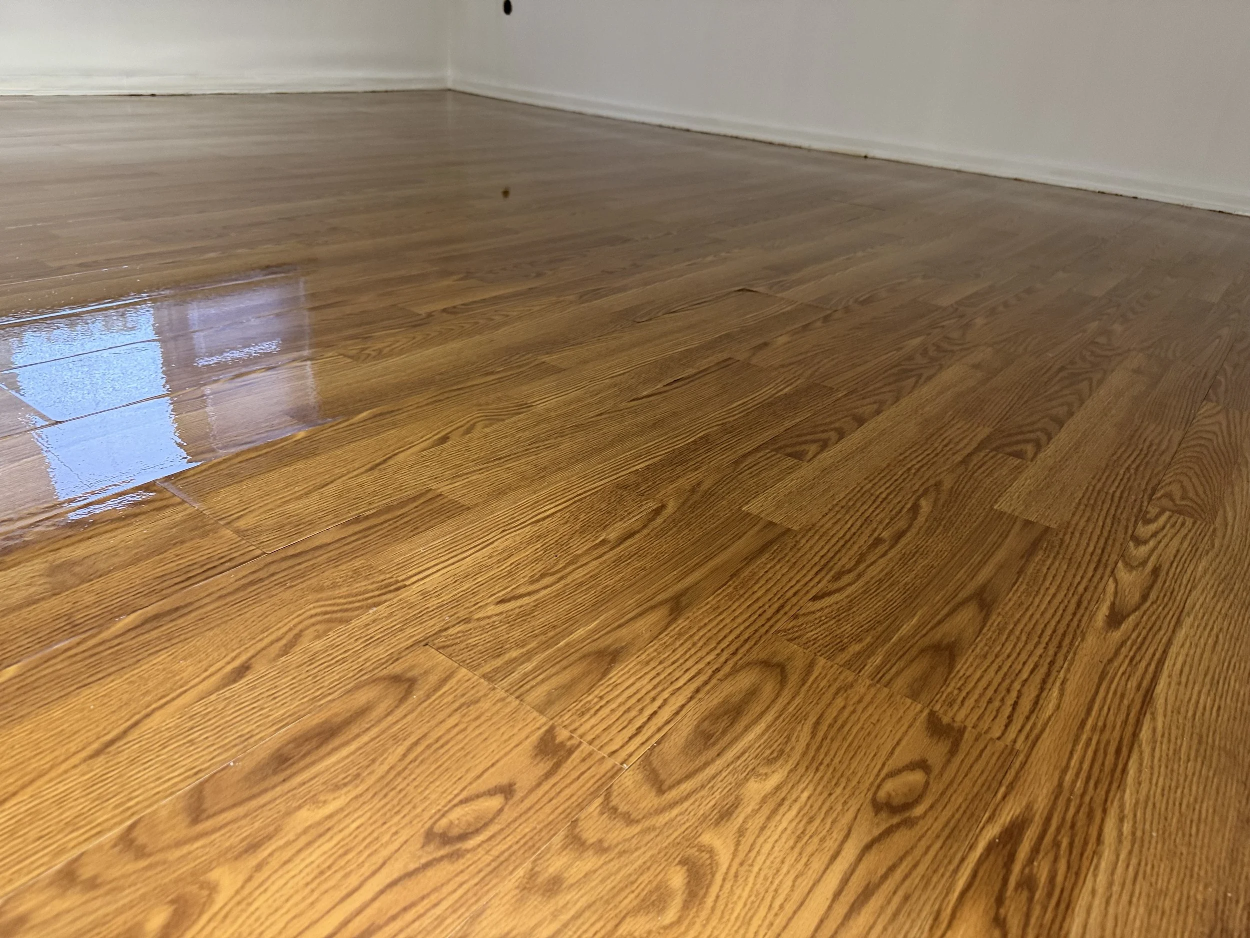 Refinished hardwood flooring with renewed natural color and a durable protective topcoat in an Oak Lawn home