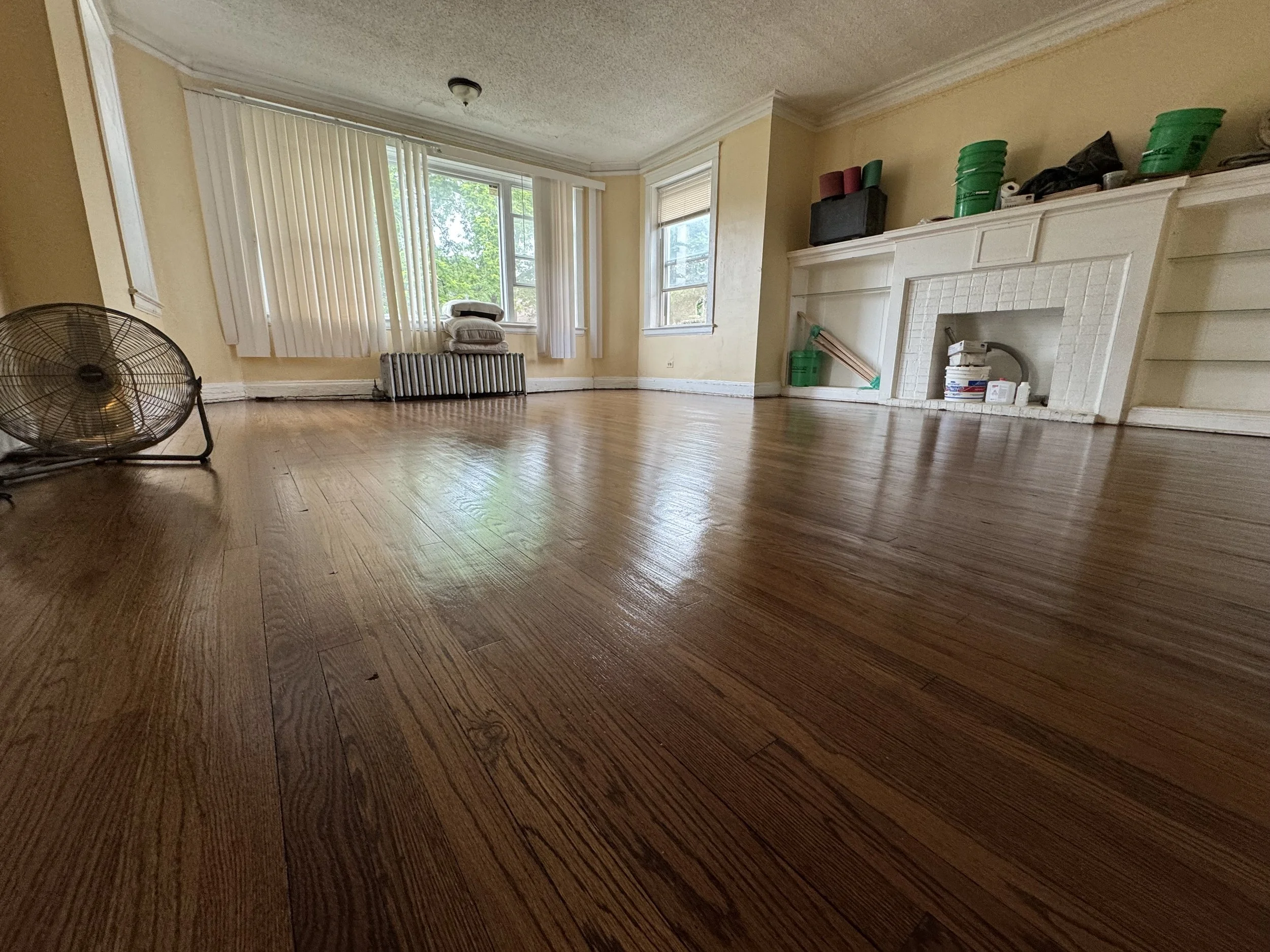 Refinished hardwood flooring with restored natural tone and a durable protective finish in a South Holland home