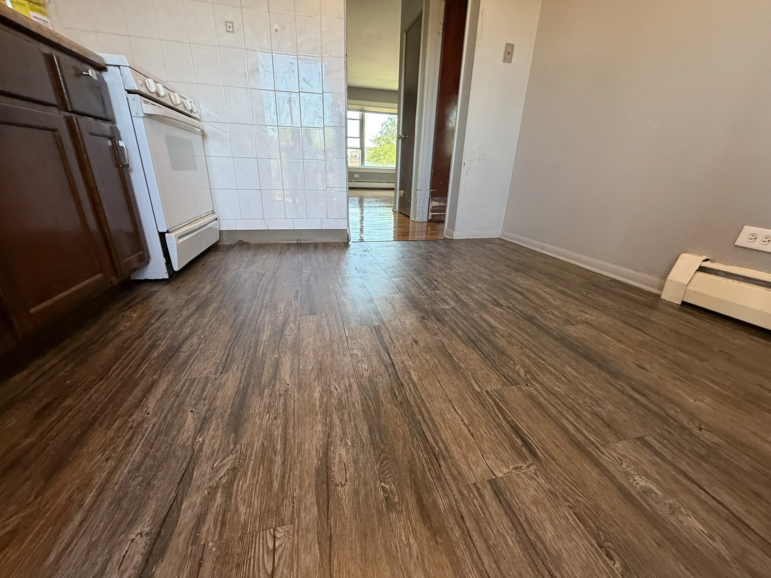 Refinished hardwood flooring with restored natural grain and durable protective finish in a Hodgkins home