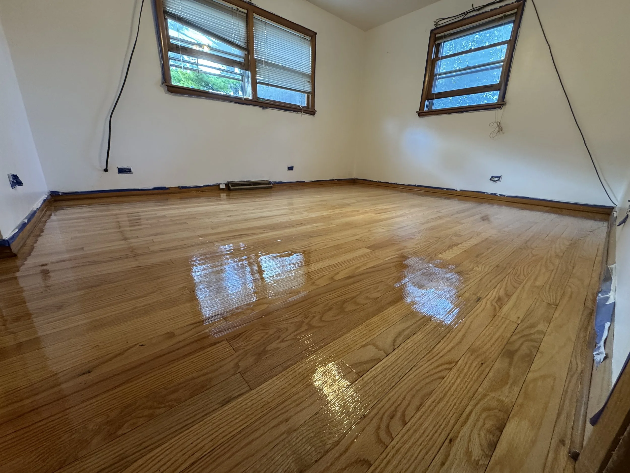 Refinished hardwood floor with restored wood grain and a durable protective finish in an Oak Forest home