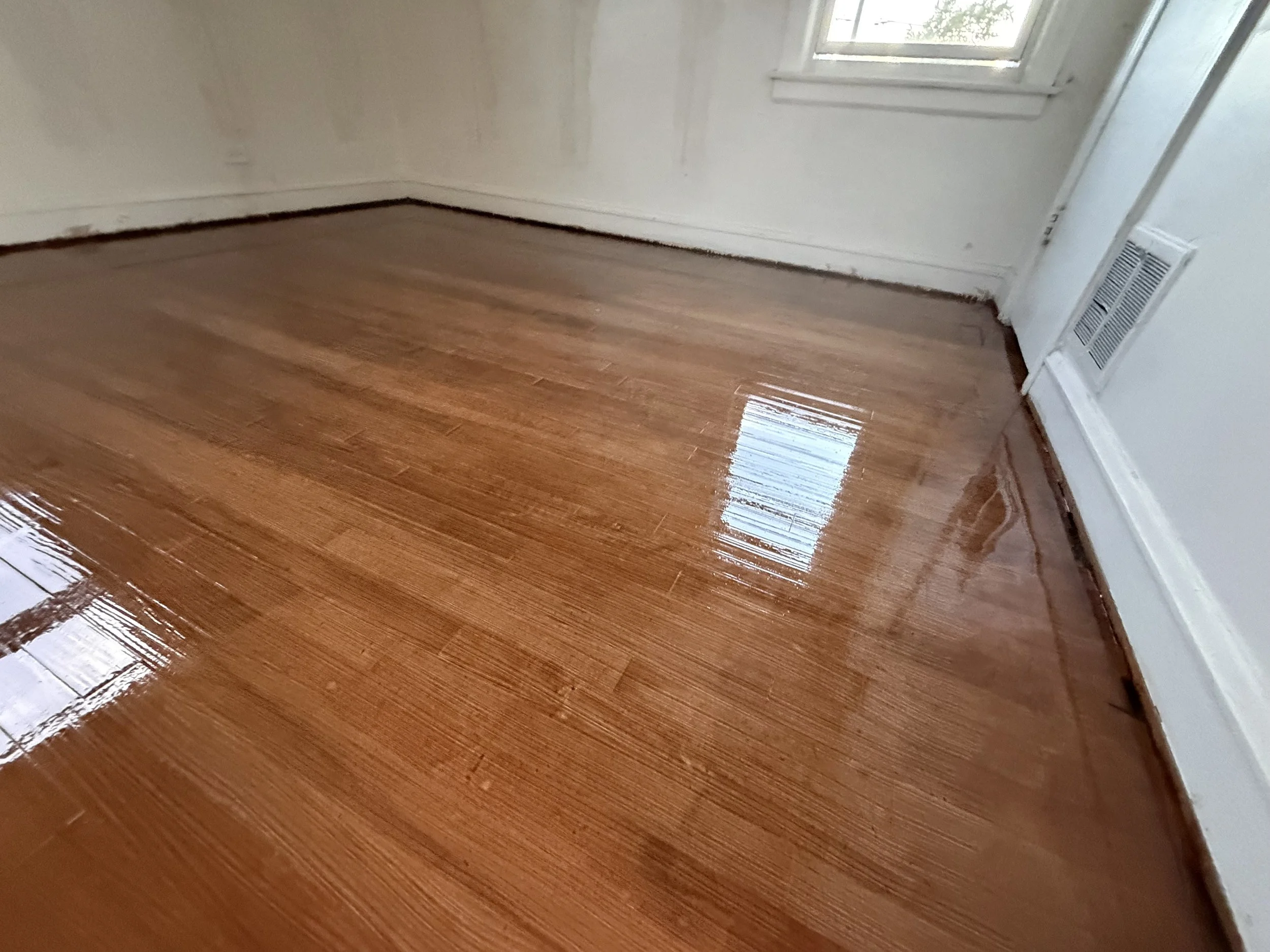 Refinished hardwood floor with renewed natural color and a durable protective finish in a Western Springs home