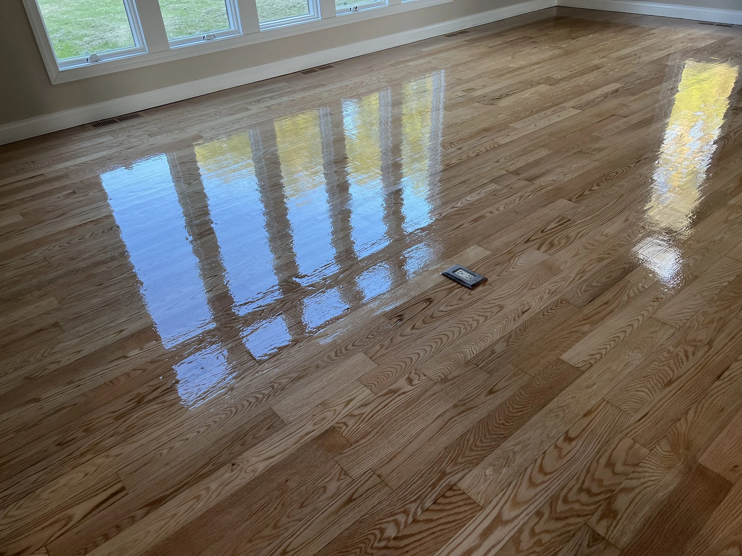 Hardwood flooring refinished to restore a smooth natural appearance