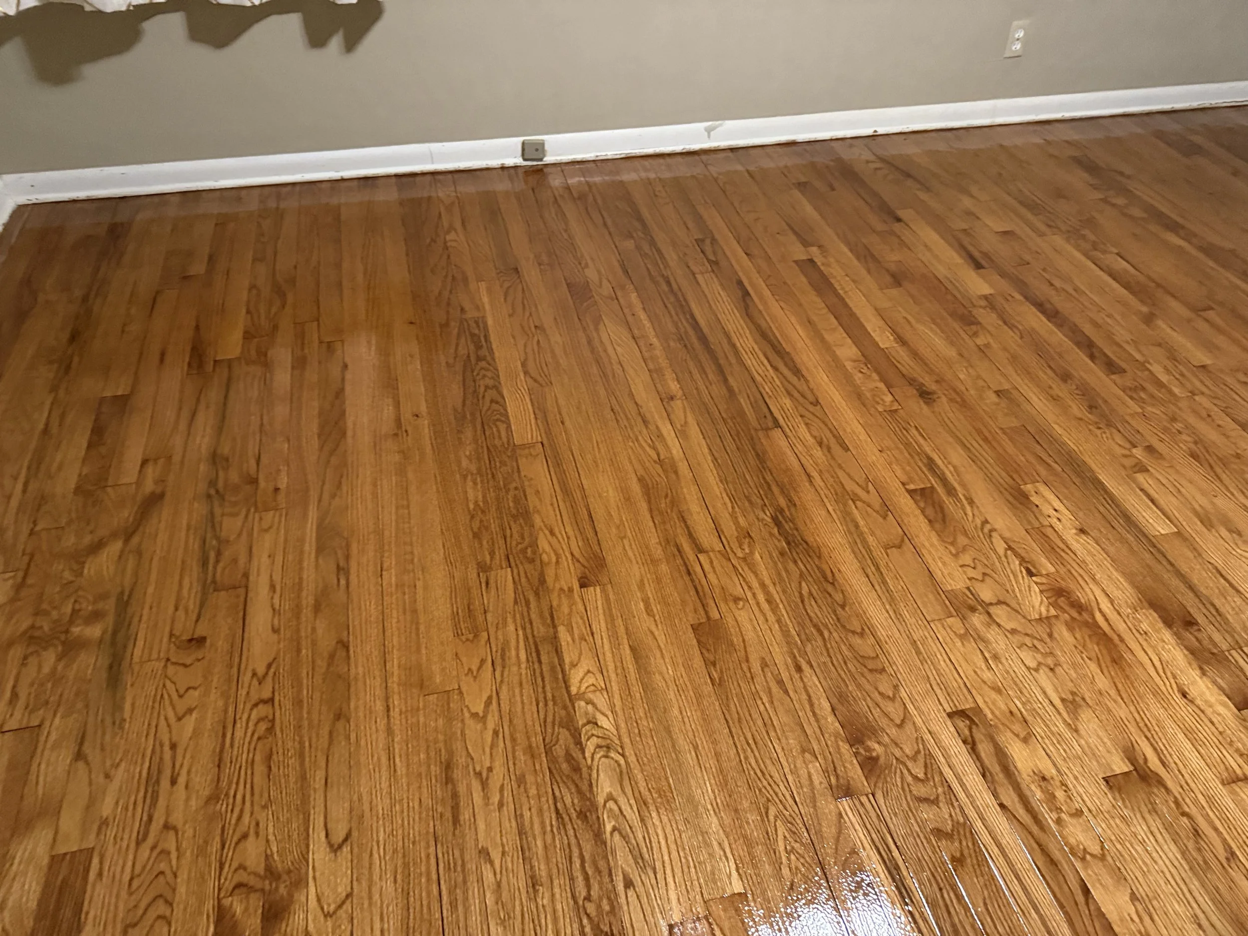 Refinished hardwood floor with a smooth protective finish