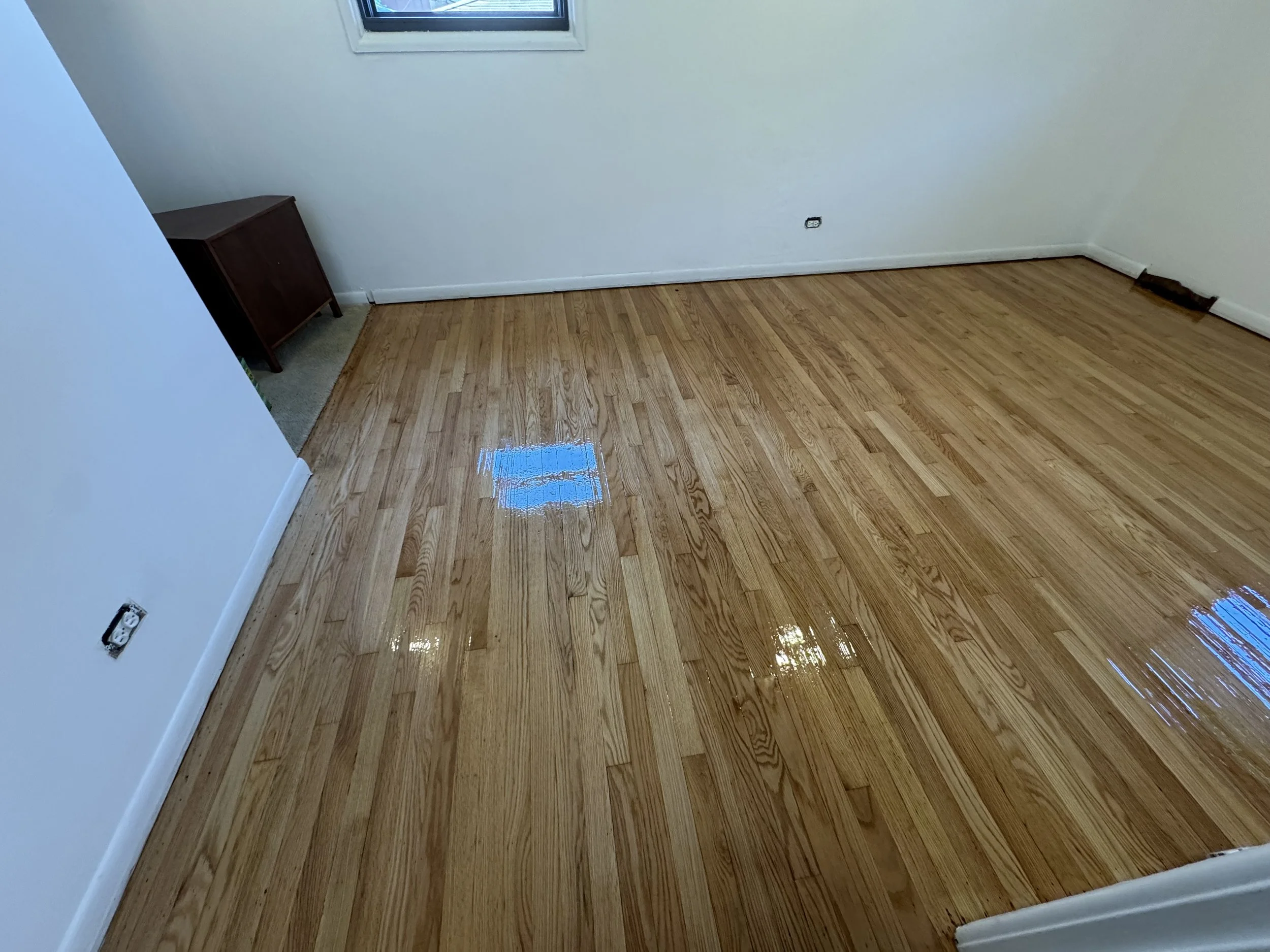 Refinished hardwood flooring with renewed natural grain and a durable protective finish in a Steger home