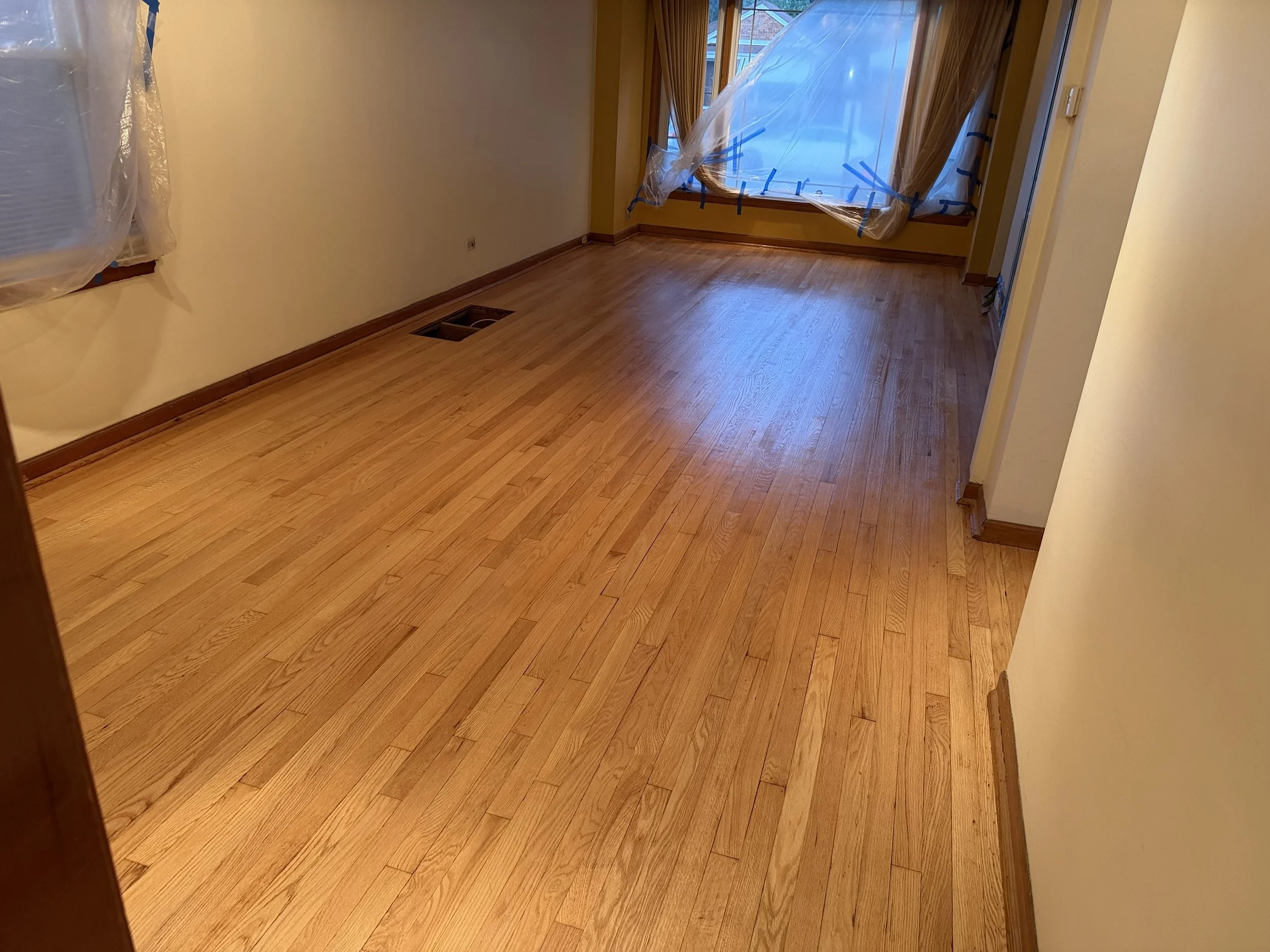 Refinished hardwood flooring with renewed natural grain and a durable protective finish in a Brookfield home