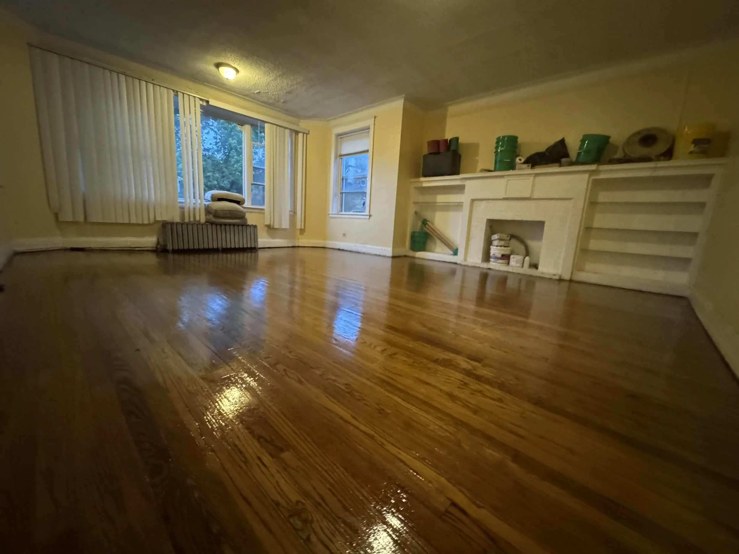 Refinished hardwood flooring with restored natural grain and a durable protective topcoat in an Earlville home