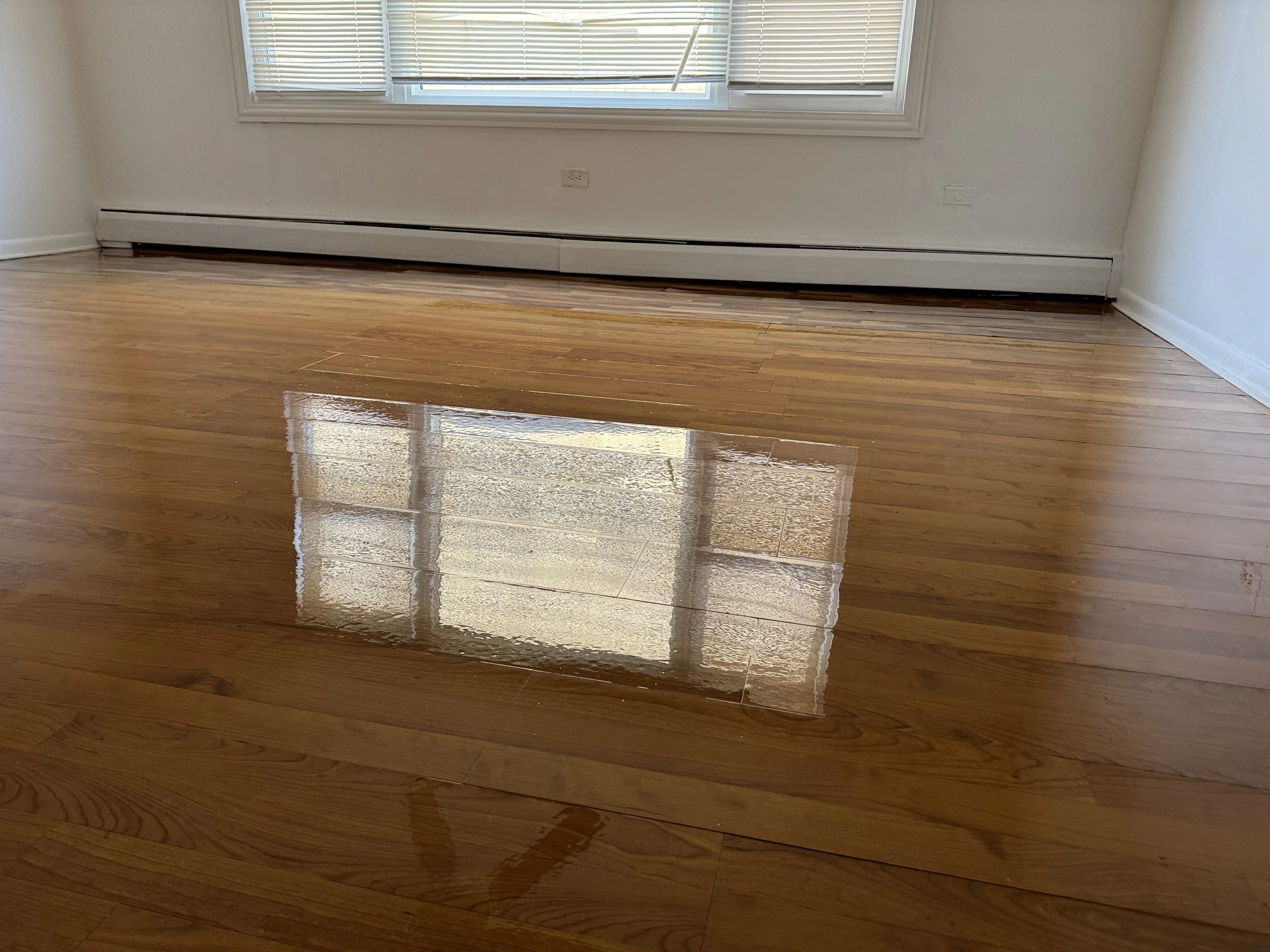 Refinished hardwood floor with restored natural tone and durable protective finish in a Flossmoor home