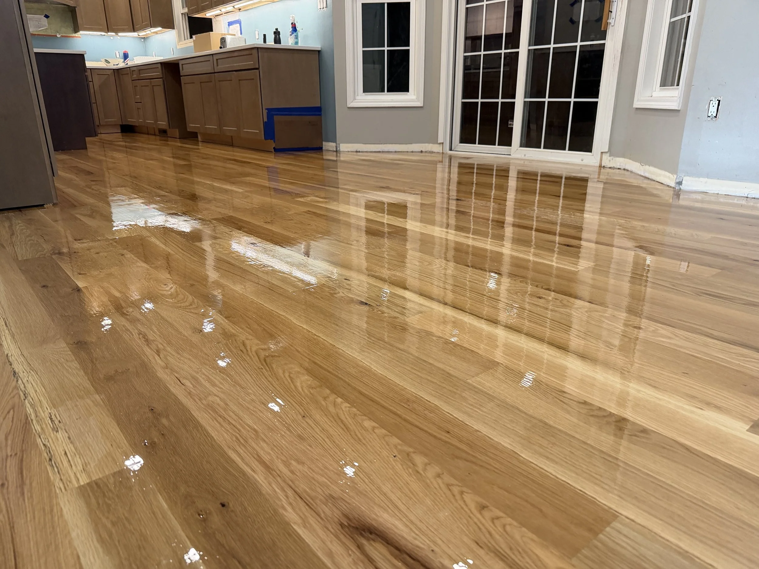 Professionally refinished hardwood flooring with restored grain and a durable clear finish