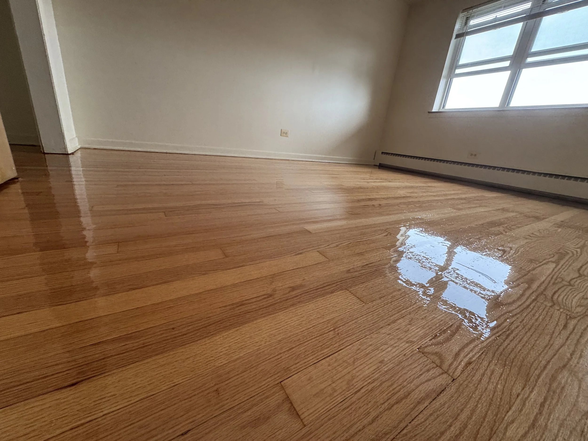 Refinished hardwood flooring with restored natural color and durable protective finish in a Markham home