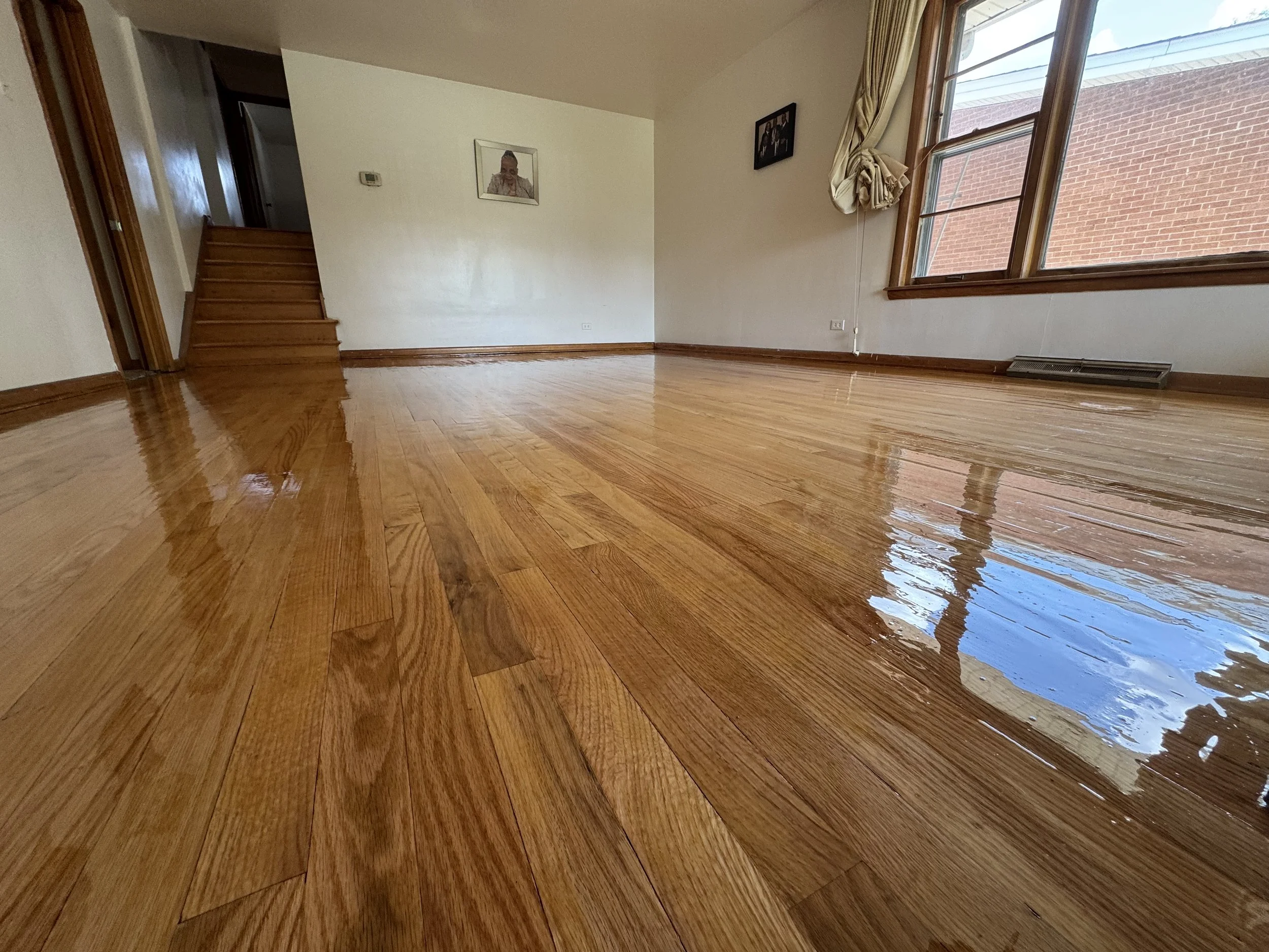 Refinished hardwood flooring with a renewed natural appearance and durable protective finish in an Alsip home