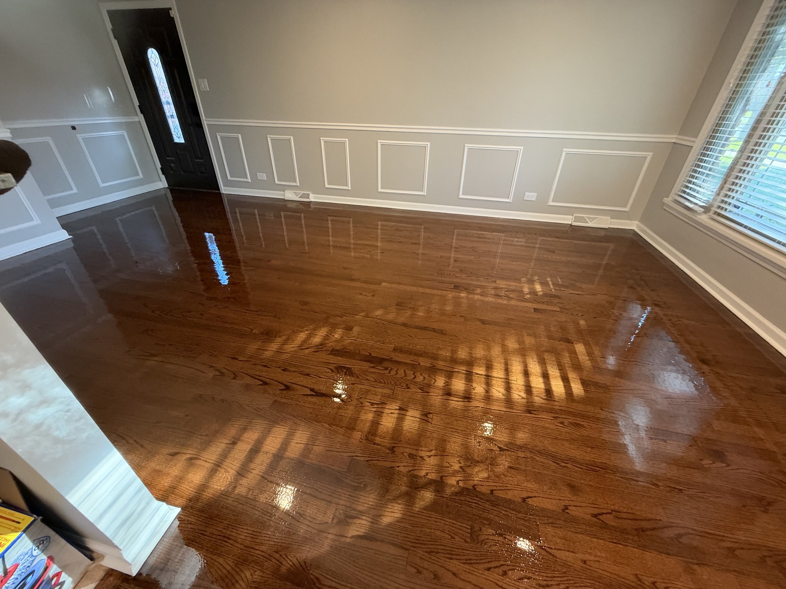 Refinished hardwood flooring with renewed wood grain and a protective finish in a South Barrington home