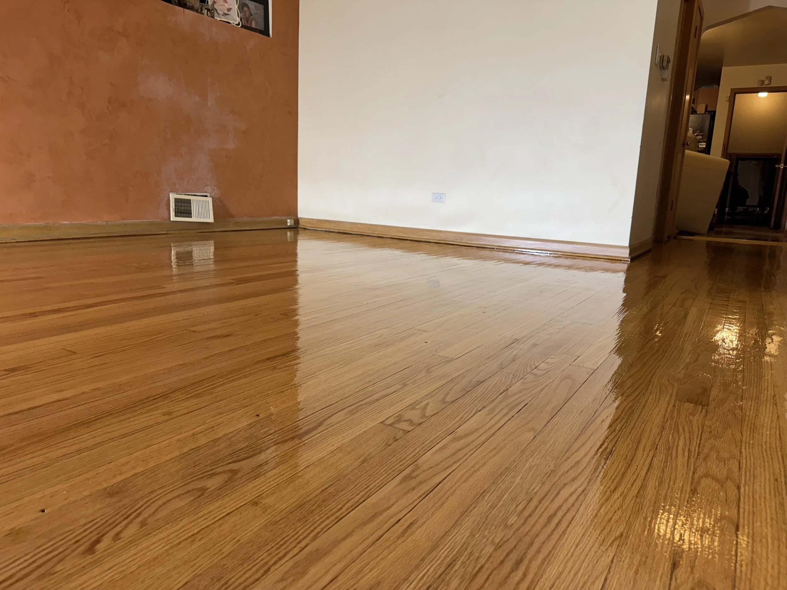 Refinished hardwood flooring with an even wood tone and durable protective finish in a Lockport home