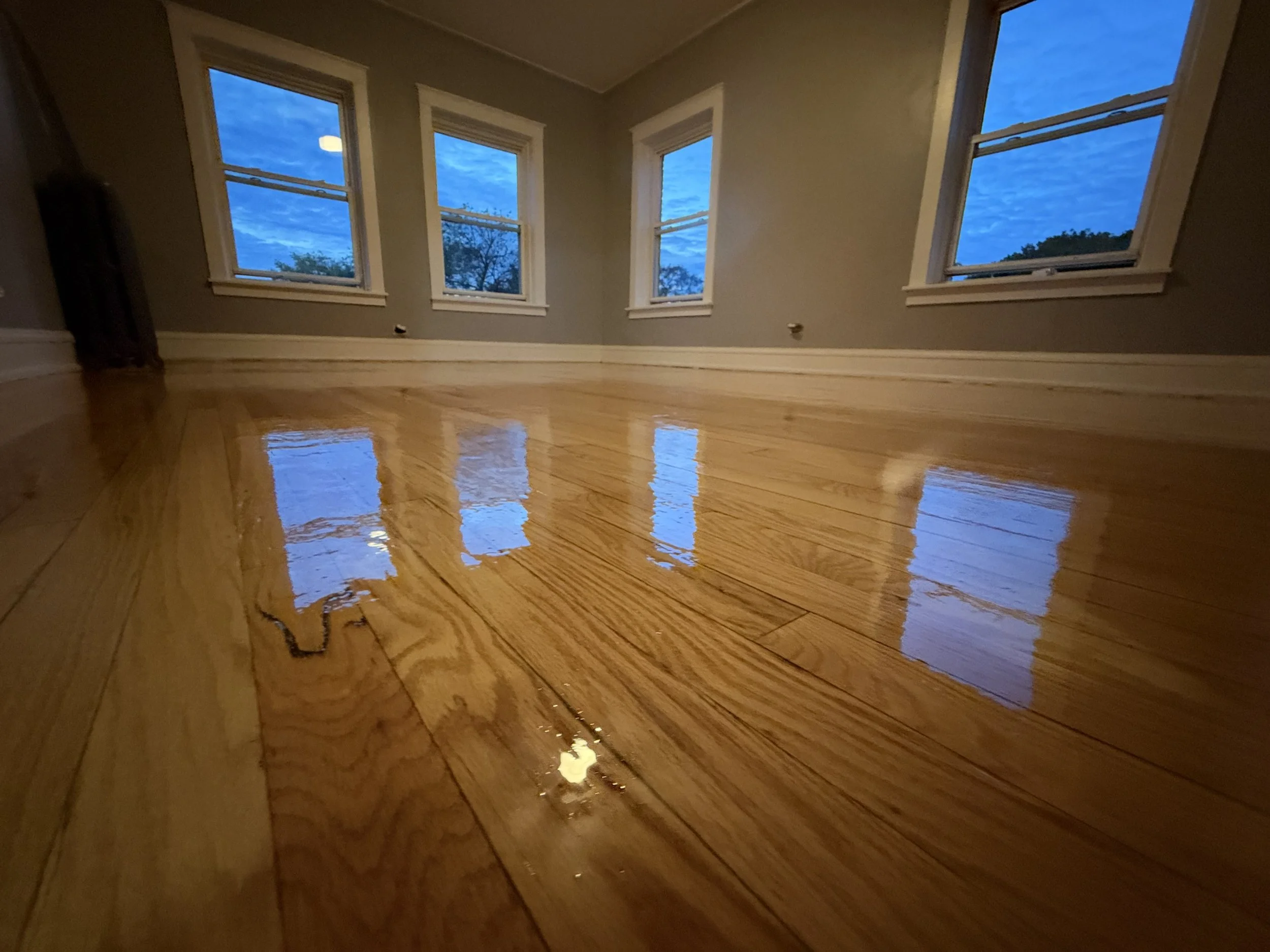 Refinished hardwood flooring with restored warm color and a protective finish in a Yorkville home