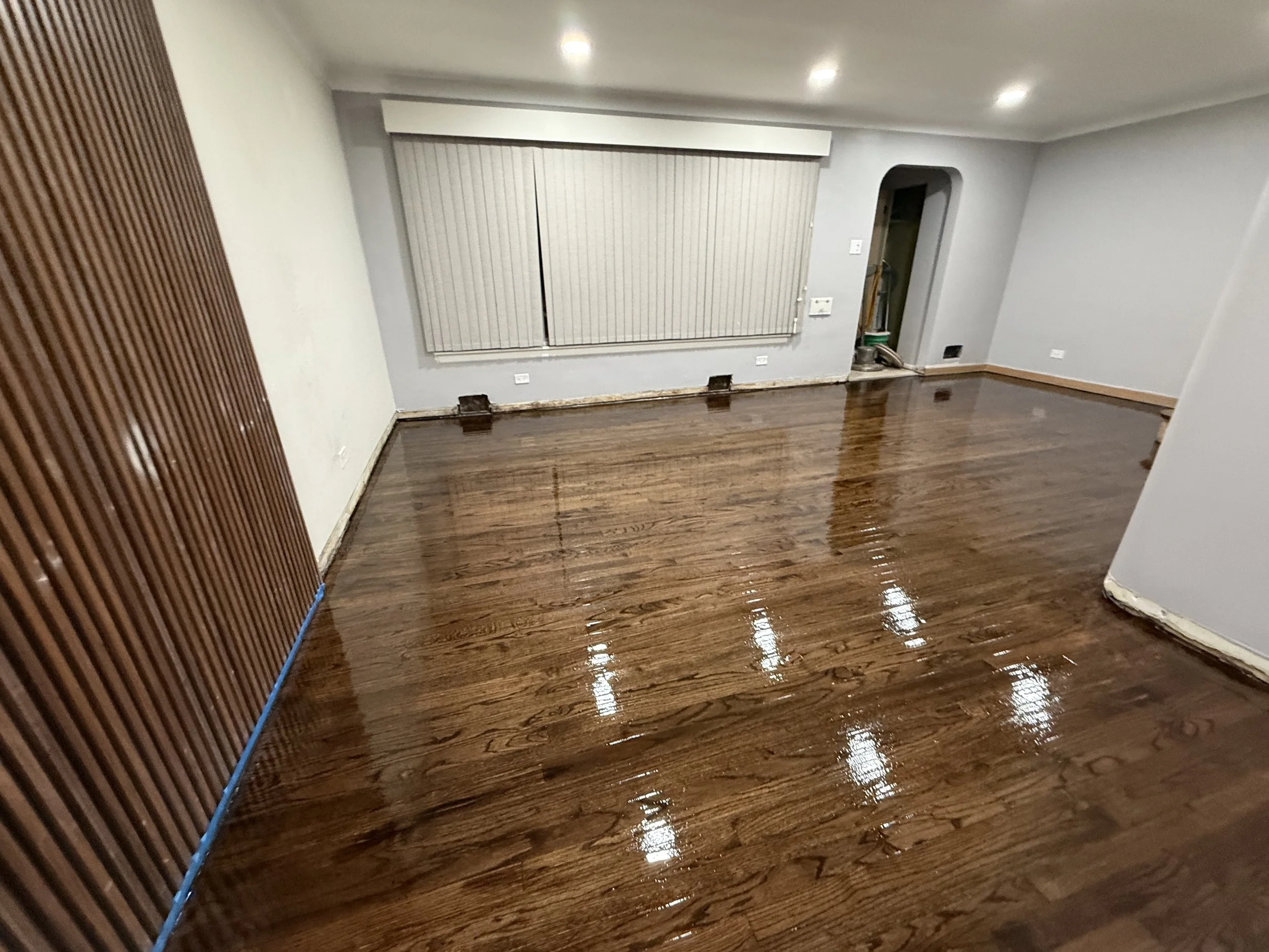 Hardwood flooring refinished with restored natural color and durable protective finish in a Stickney home