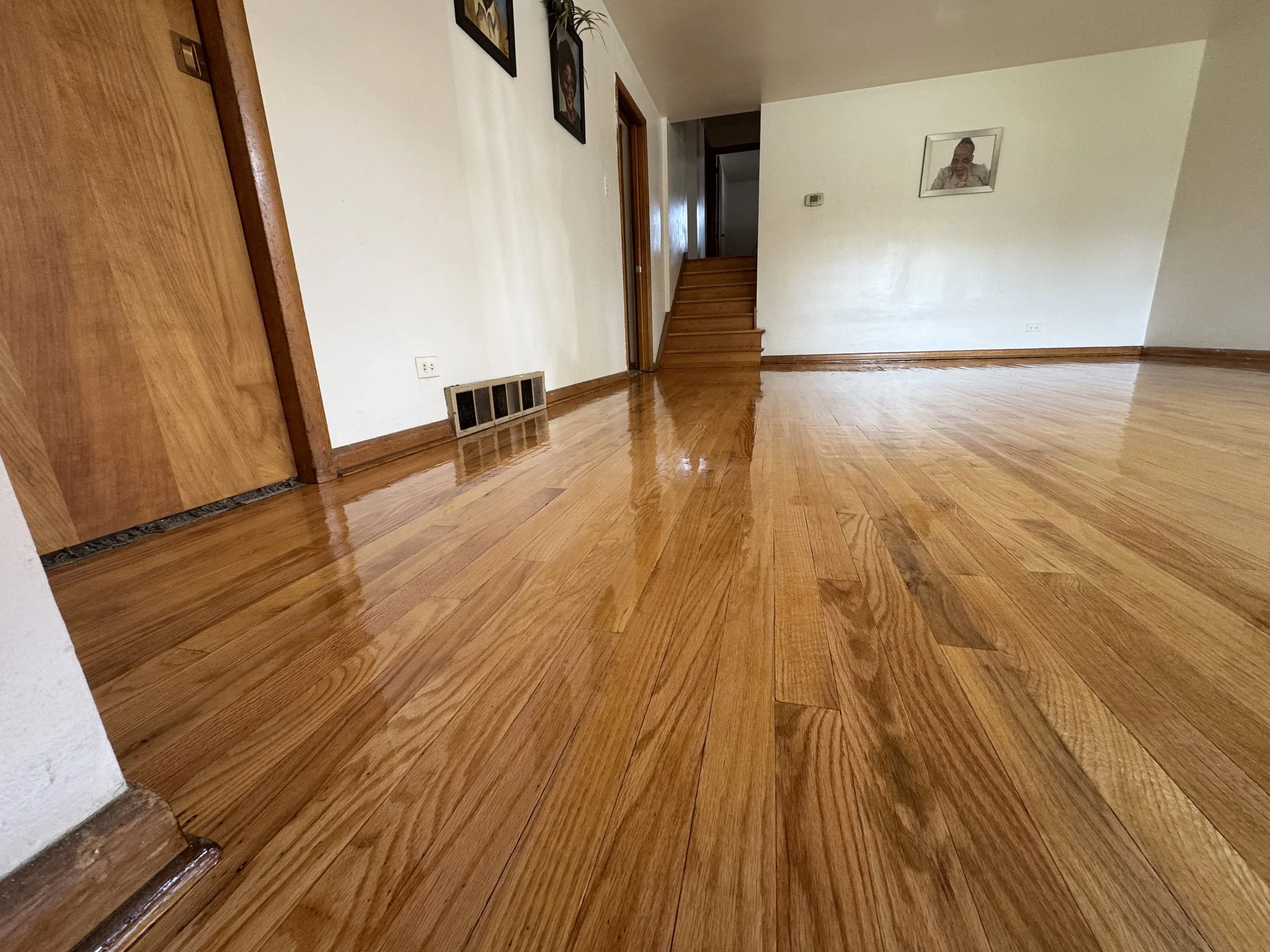 Hardwood floor refinished with restored color and a durable protective finish in a Palos Heights home