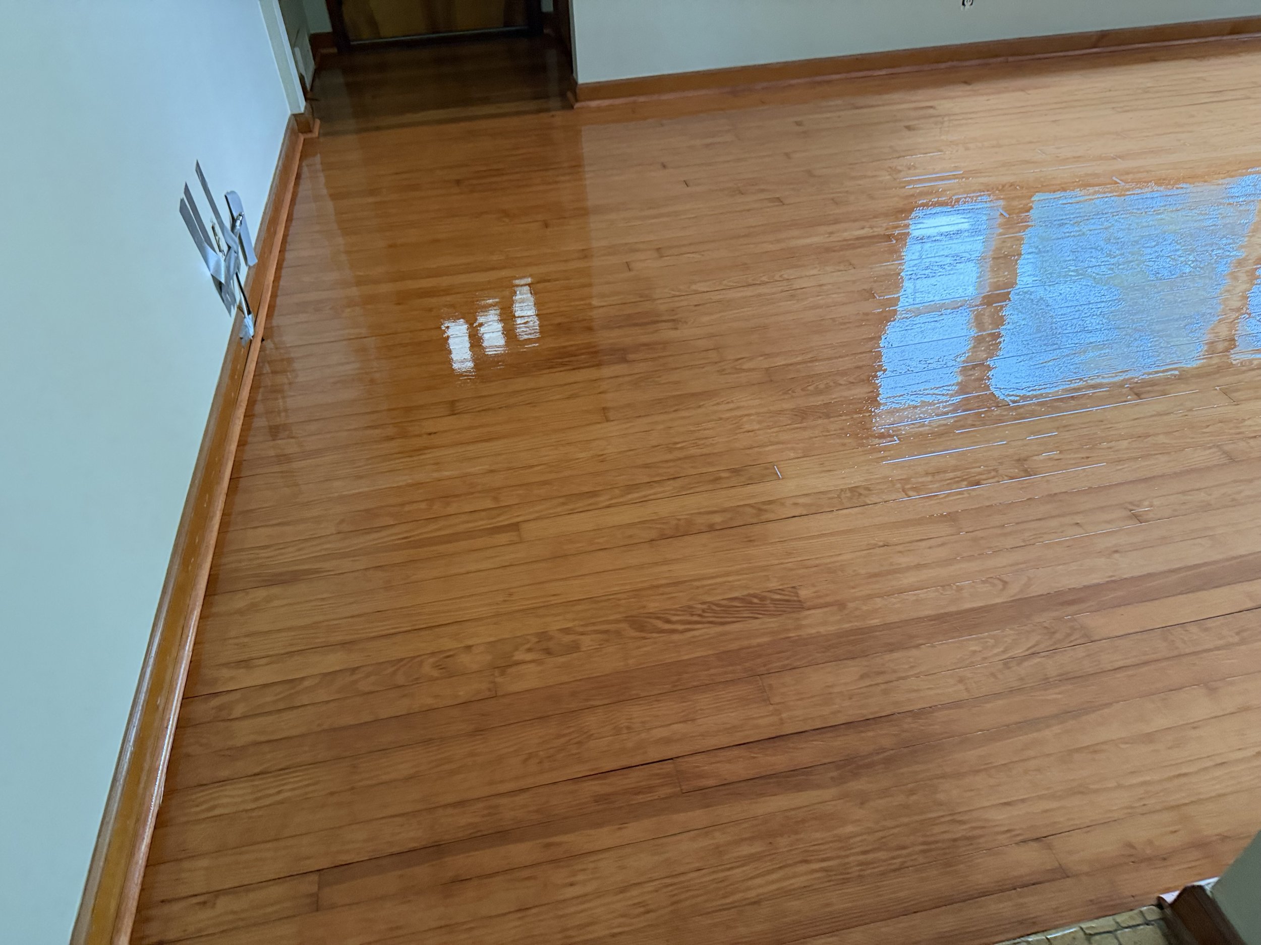 Refinished hardwood floor with a smooth protective finish