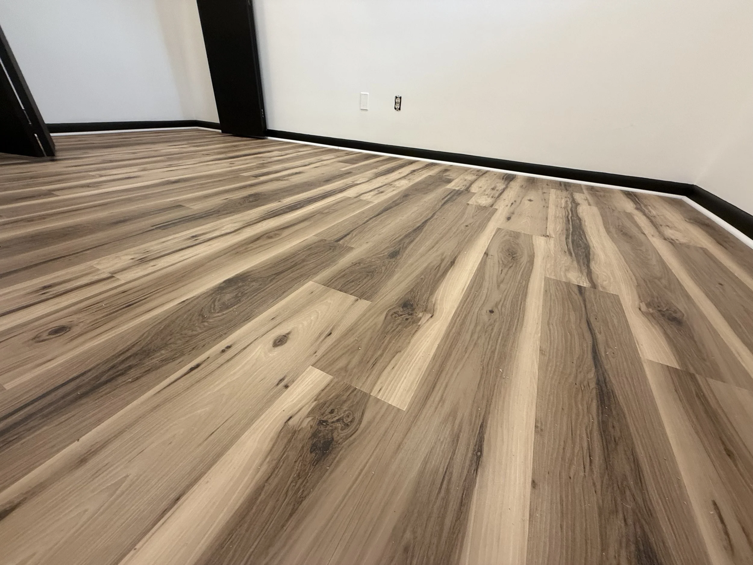 Hardwood floor refinished with restored natural grain and a durable protective topcoat in a Hinckley home