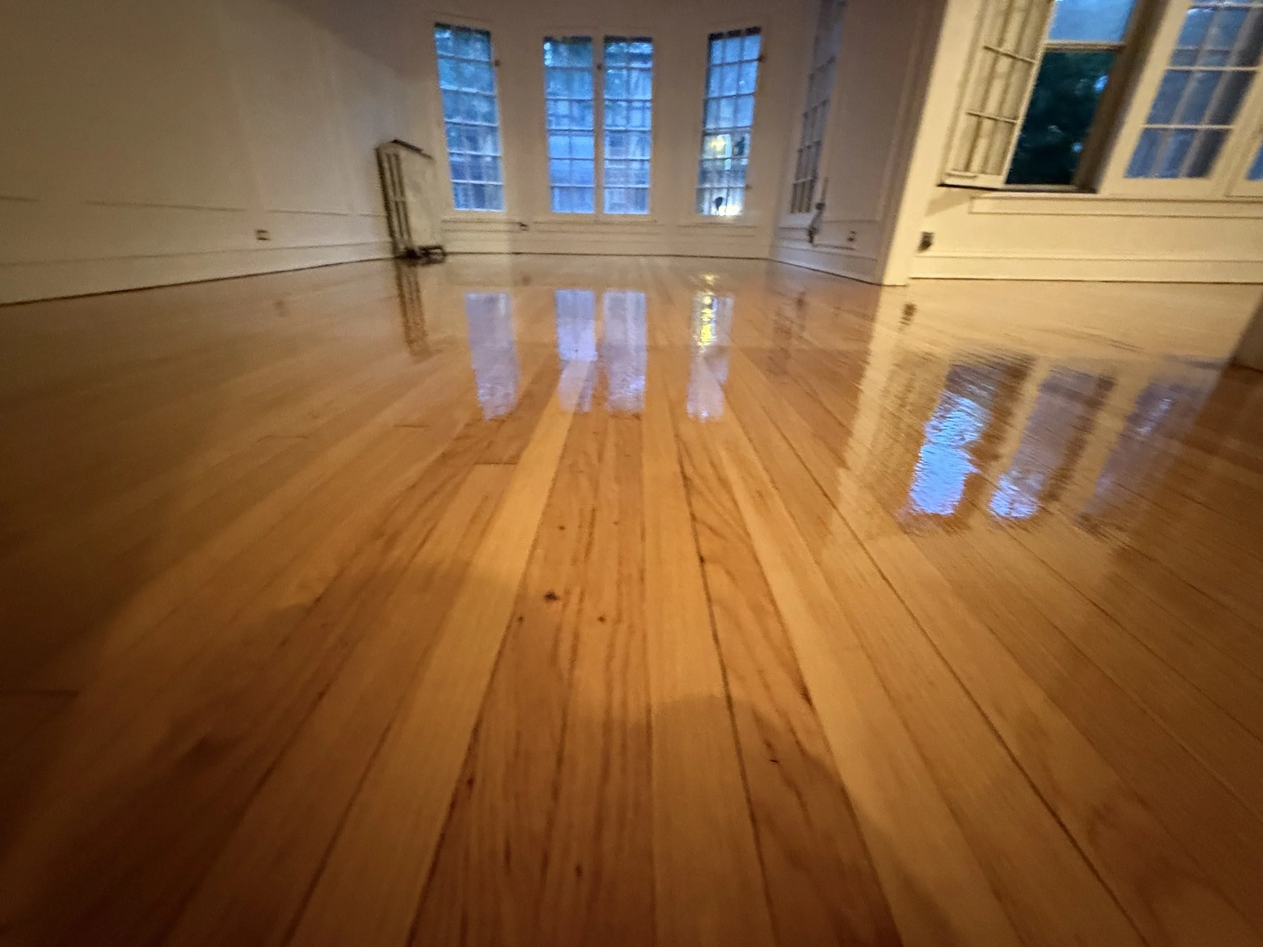 Hardwood floor refinished with a refreshed natural appearance and durable protective finish in a Montgomery home
