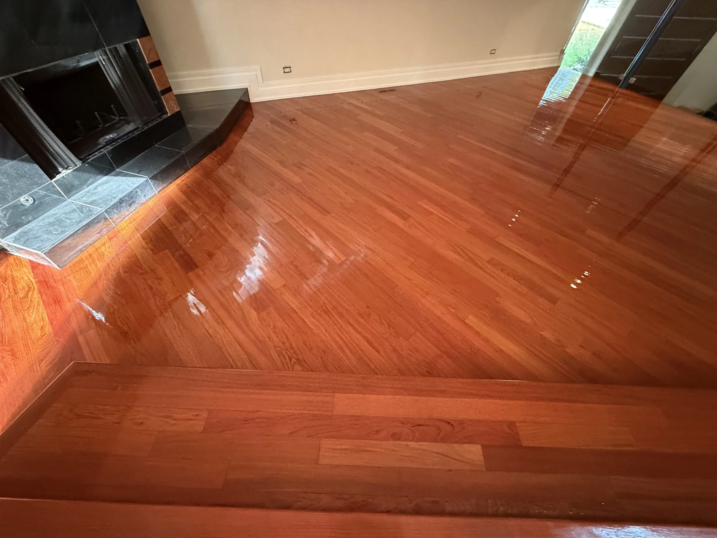 Hardwood floor renewed through sanding and refinishing with a durable clear coat