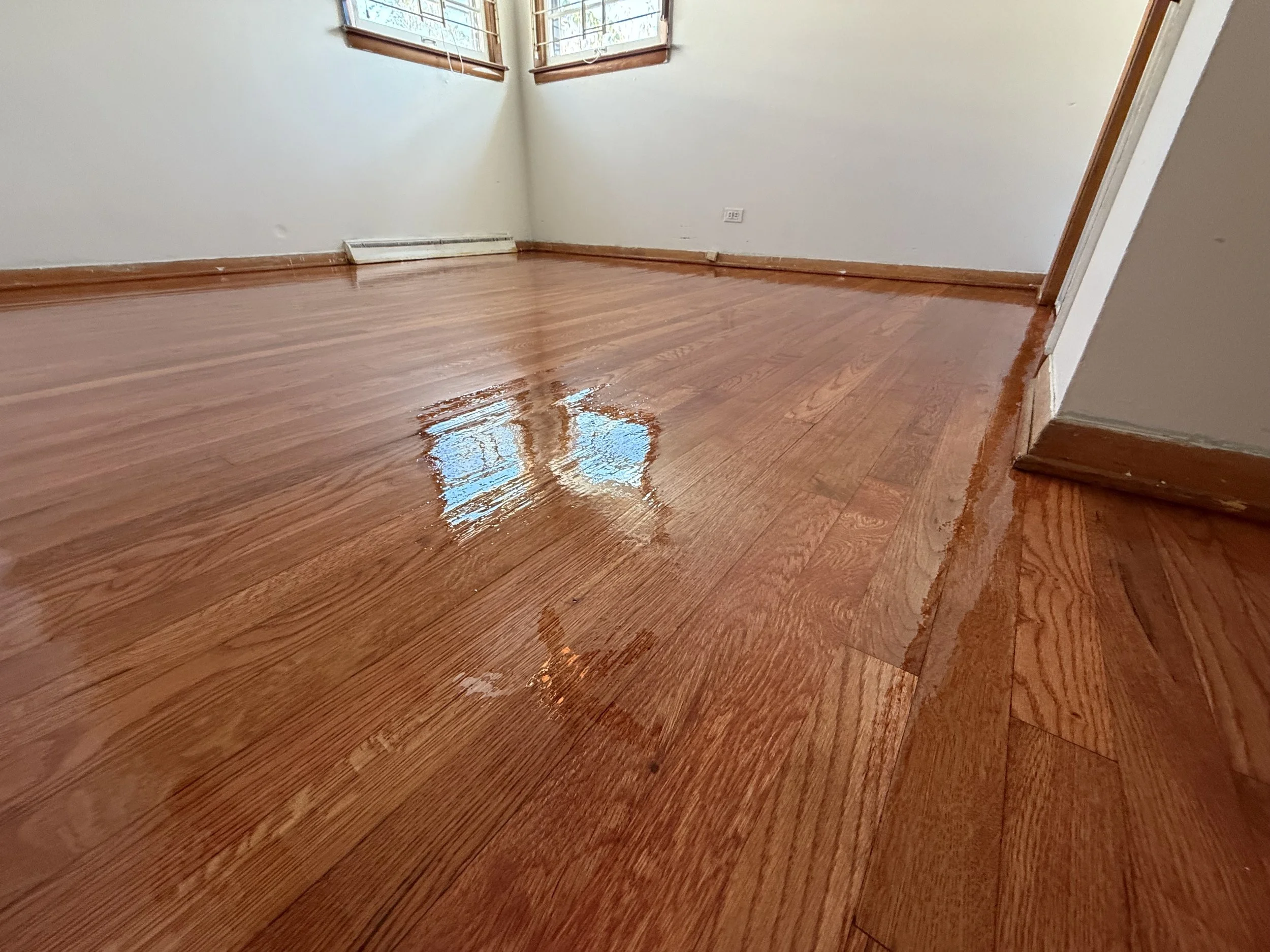 Restored hardwood flooring with renewed color and protective finish in a Creston, Illinois home