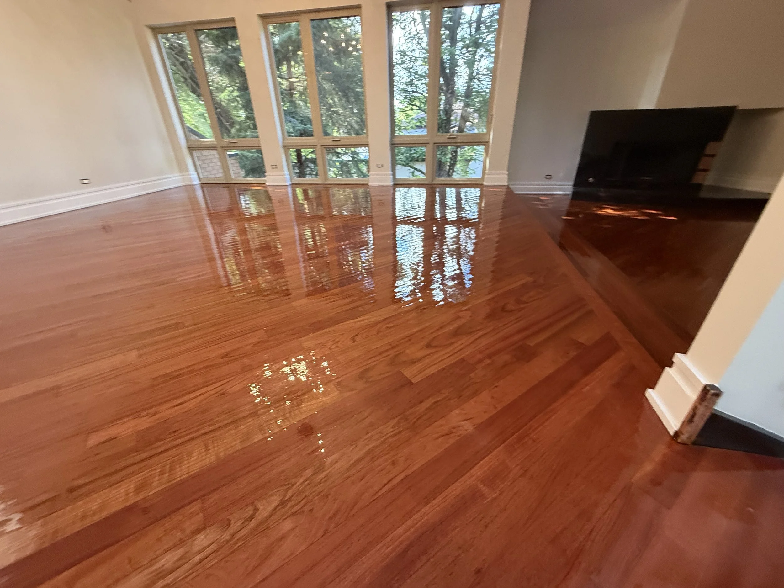 Hardwood floor restored with a smooth finish, natural grain, and renewed shine