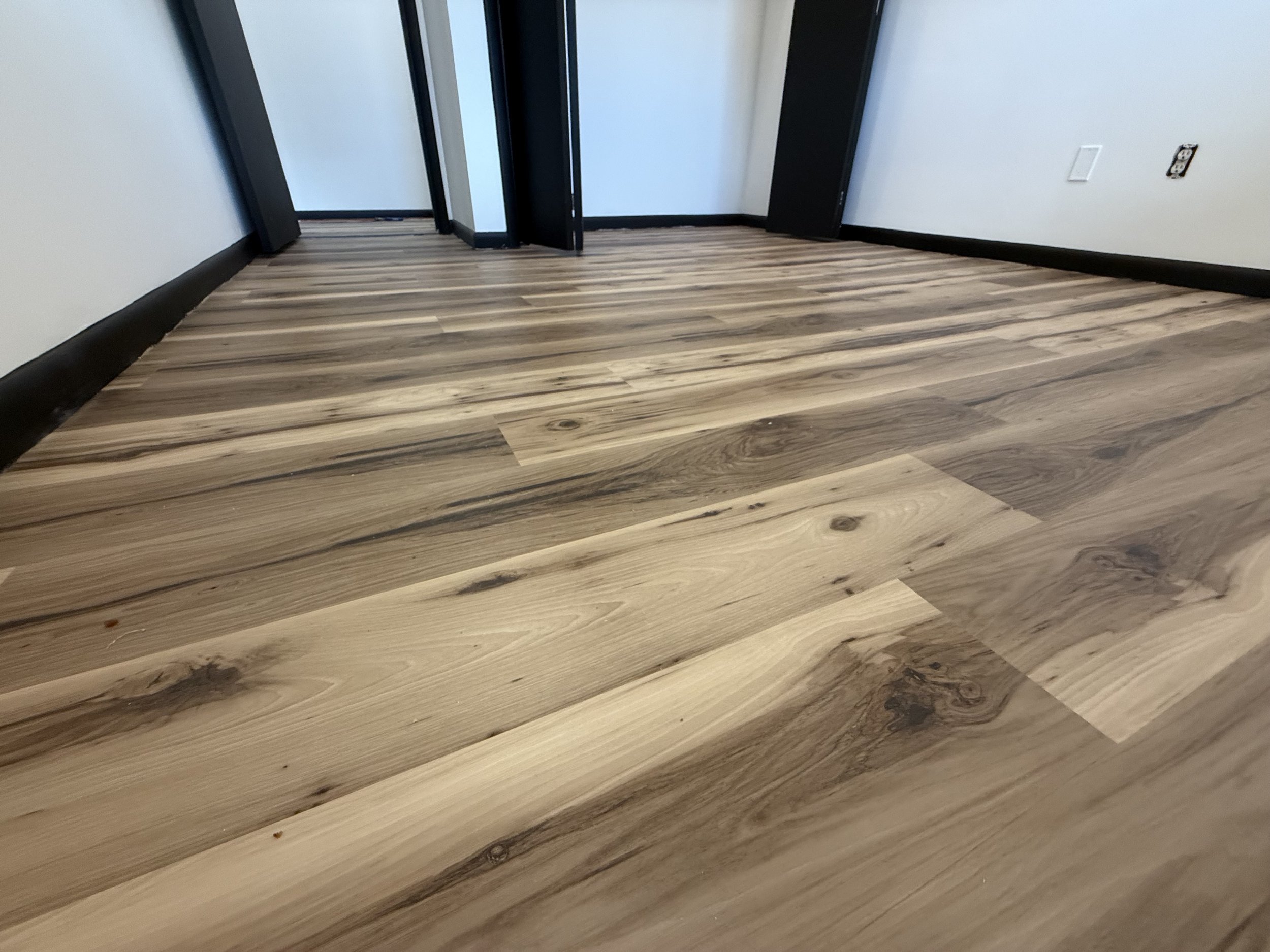 Restored hardwood flooring with a renewed smooth finish and natural wood tone in a Lisbon home