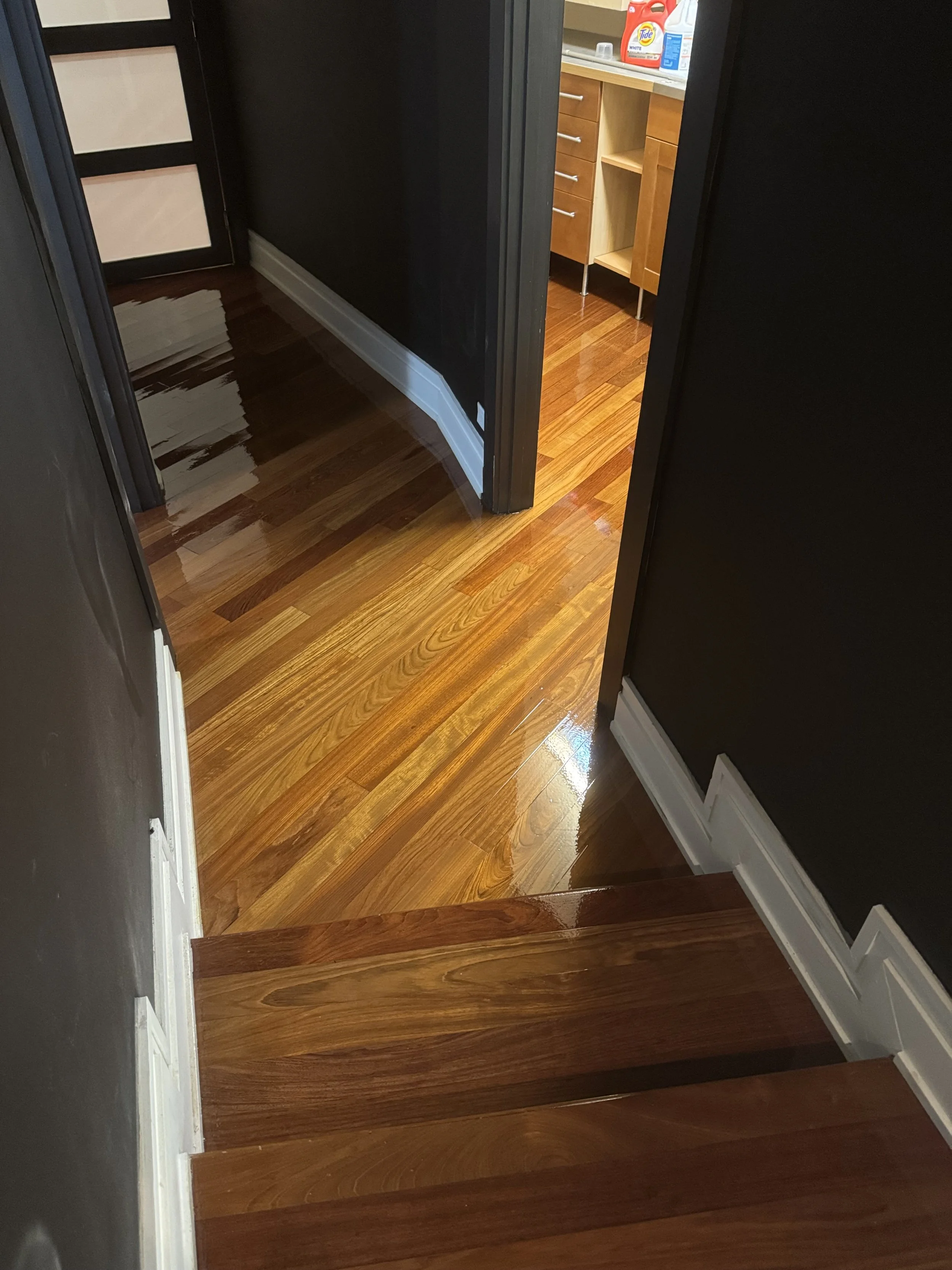 Hardwood floor refinished to restore an even tone, natural grain, and smooth surface