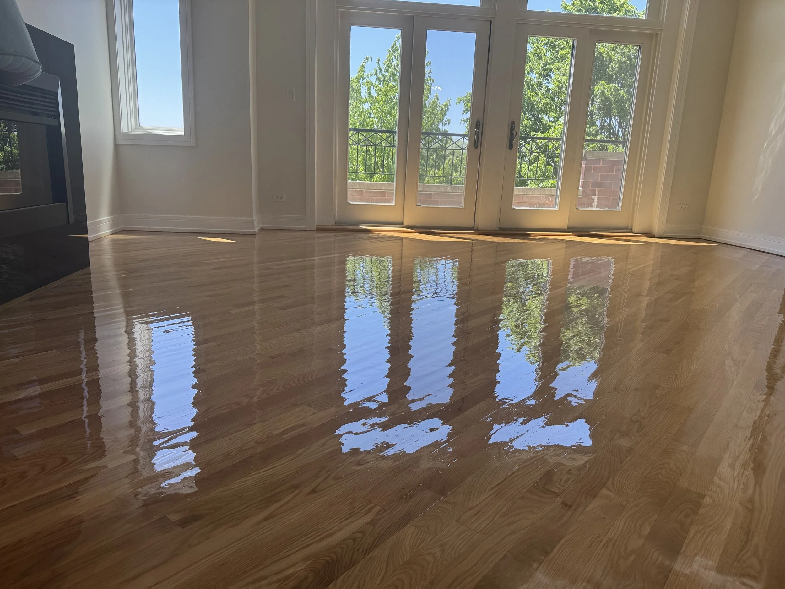 Hardwood floor refinished with restored natural color and a durable protective coating in a Shorewood home