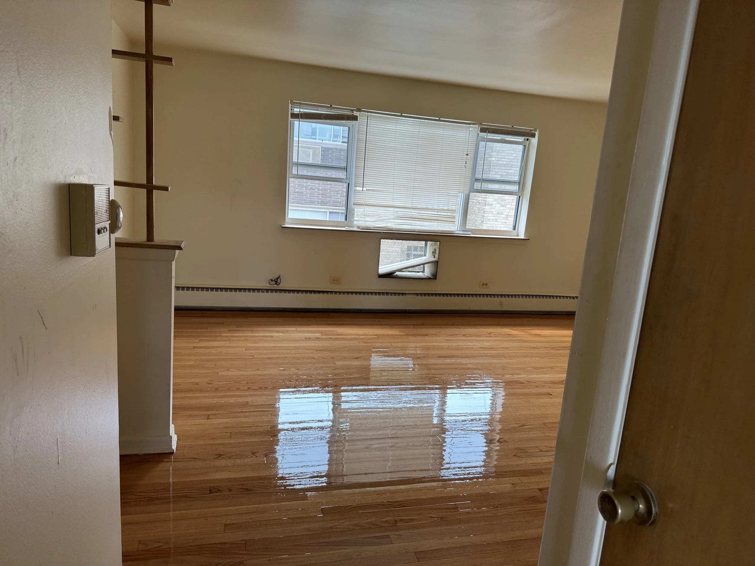 Refinished hardwood floor with renewed natural wood color and durable protective finish in a Harvey home