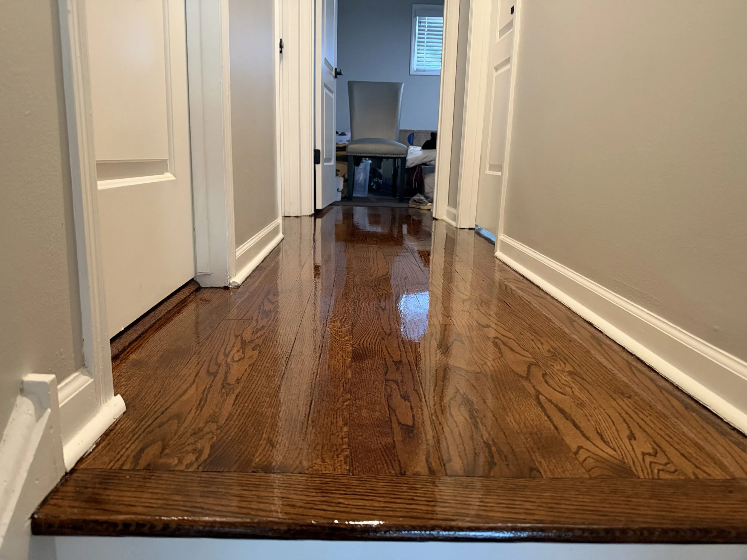 Refinished hardwood flooring with renewed color and a protective finish in a Palatine home
