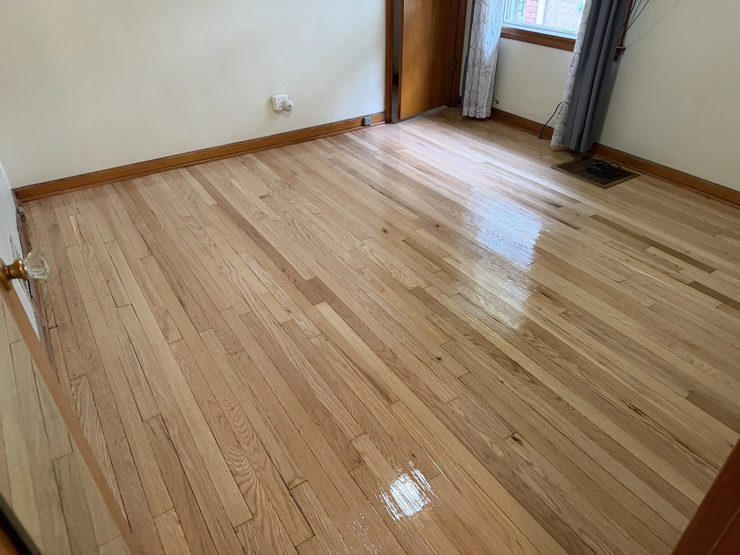 Hardwood flooring refinished with renewed warmth and durable protective finish in a La Grange home