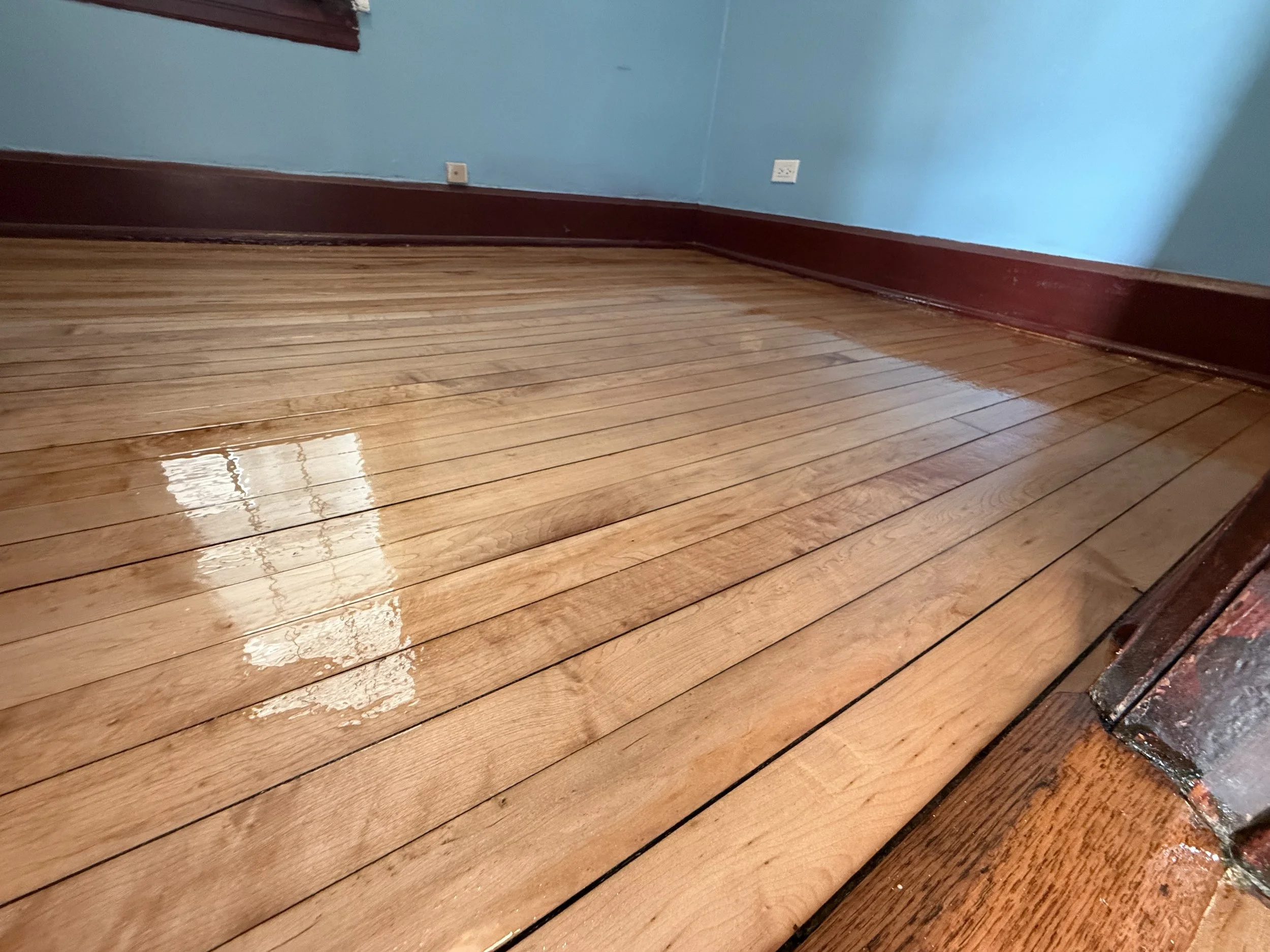 Refinished hardwood floor with restored wood grain and a durable protective finish in a Lemont home