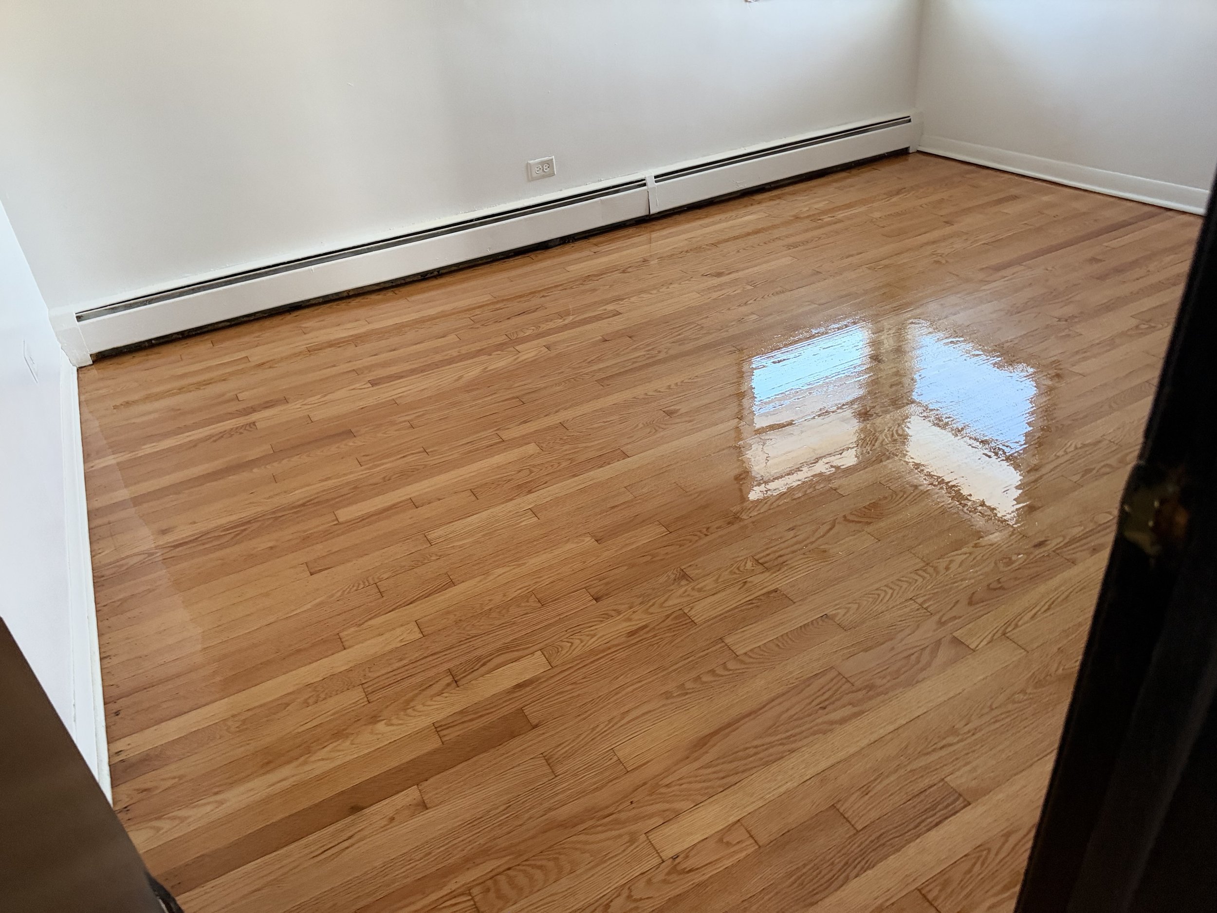 Hardwood flooring refinished with renewed color and a protective finish in a Schaumburg home