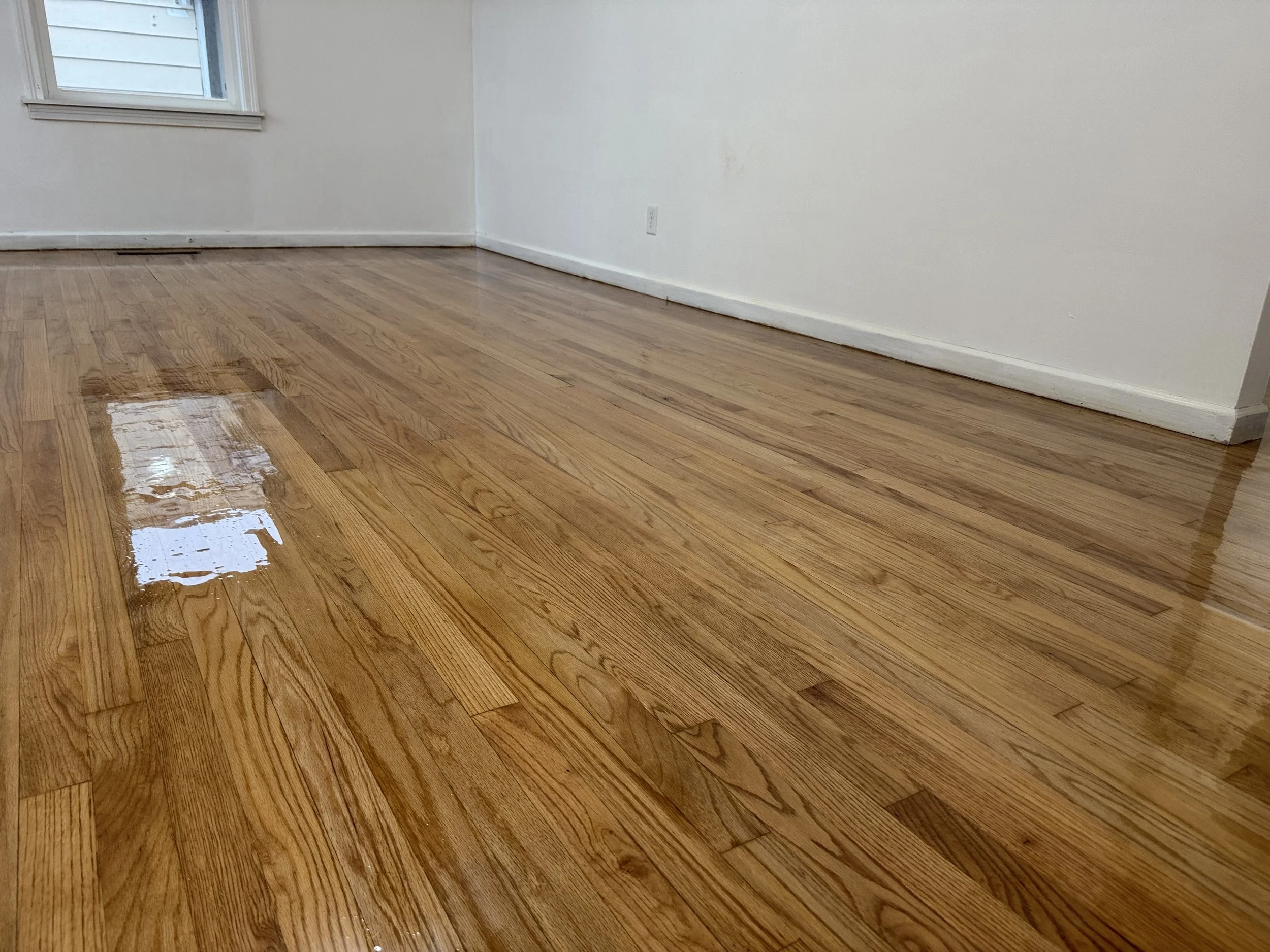 Refinished hardwood flooring with renewed color and a durable protective finish in a Minooka home