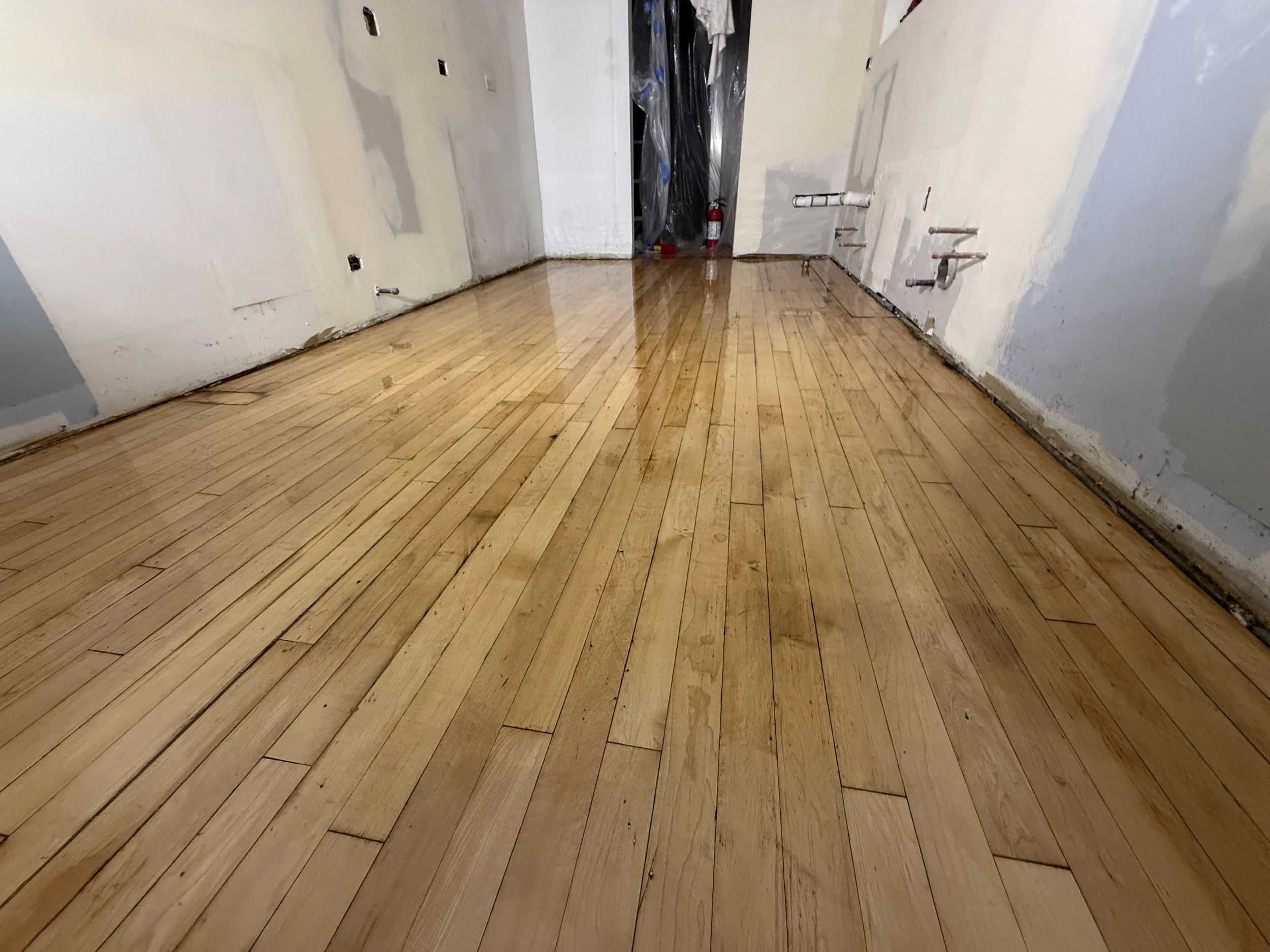 Refinished hardwood flooring with restored color and a long-lasting protective finish in a Darien home