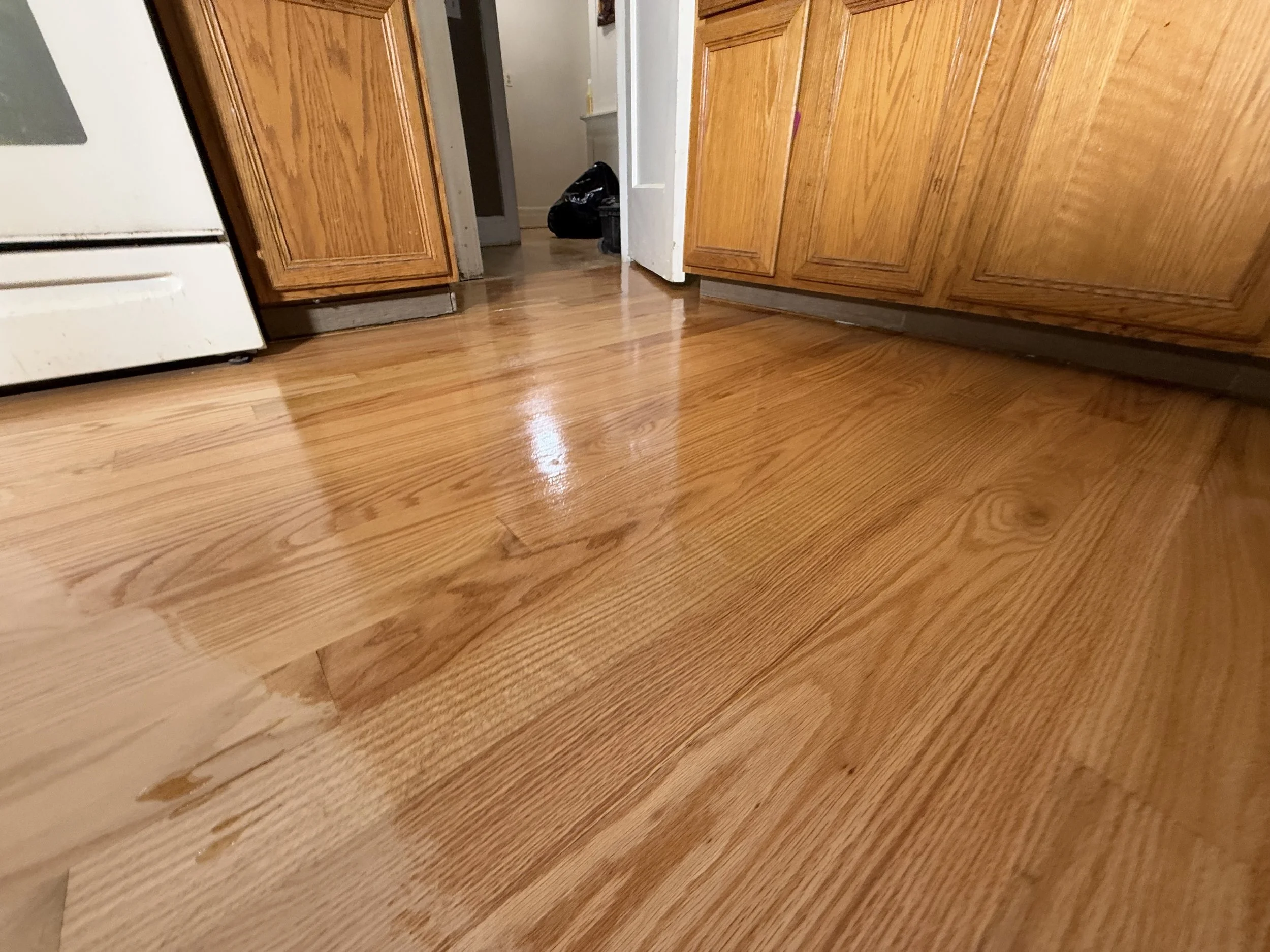 Hardwood floor refinished with a refreshed appearance and protective coating in a Hoffman Estates home