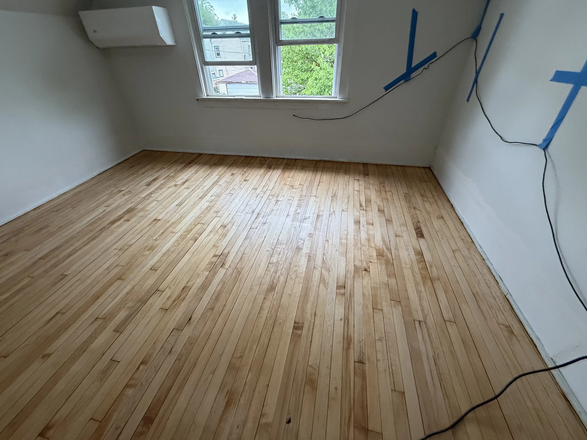 Hardwood floor refinished with renewed natural tone and a durable protective finish in a Westmont home